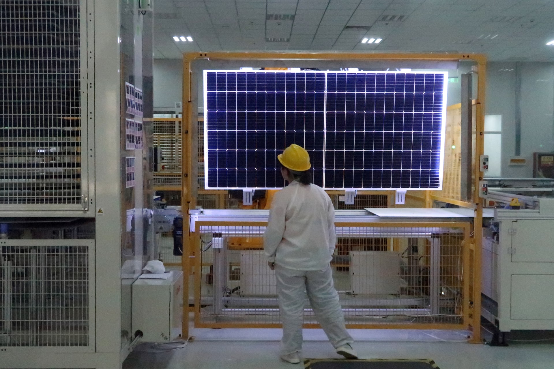 A worker conducts quality-check of a solar module product at a factory of a monocrystalline silicon solar equipment manufacturer LONGi Green Technology Co, in Xian, Shaanxi province, China December 10, 2019. Picture taken December 10, 2019. REUTERS/Muyu Xu