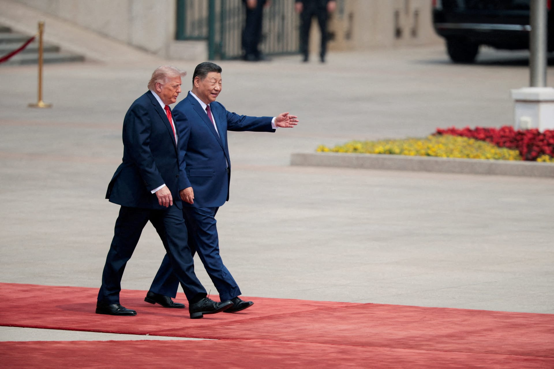 <p>U.S. President Donald Trump walks with Chinese President Xi Jinping upon arrival at the Great Hall of the People in Beijing, China, May 14, 2026.</p>
