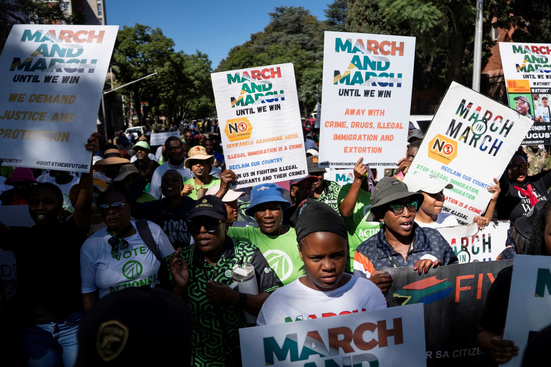 <p>Members of civil society groups and human rights organizations hold placards as they take part in a march calling for stronger government action against illegal immigration in Pretoria, South Africa, on April 28, 2026.</p>
