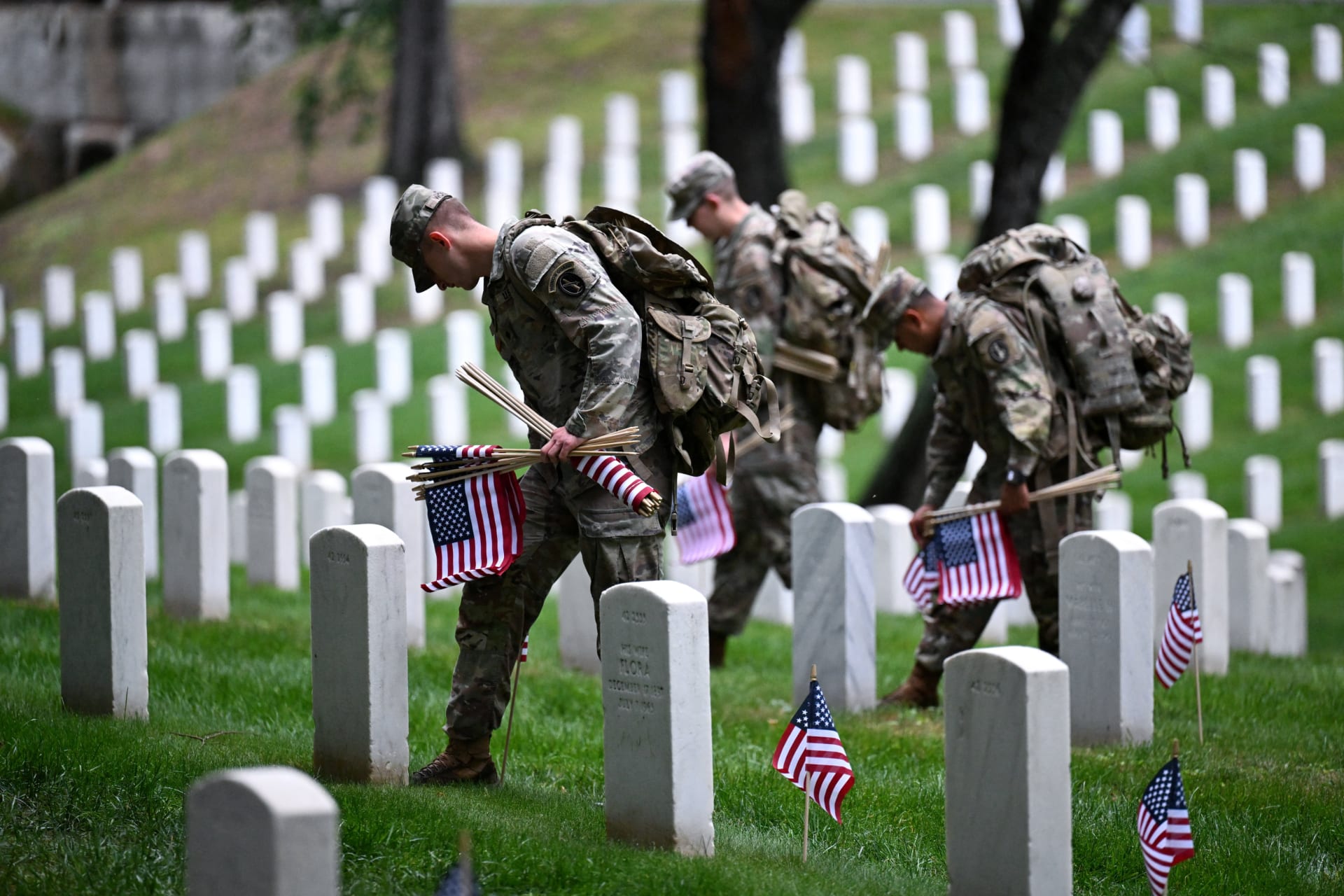 <p>Soldiers from the U.S. Army 3d Infantry Regiment, known as The Old Guard, place flags at service members’ graves in Arlington National Cemetery, May 21, 2026.</p>
