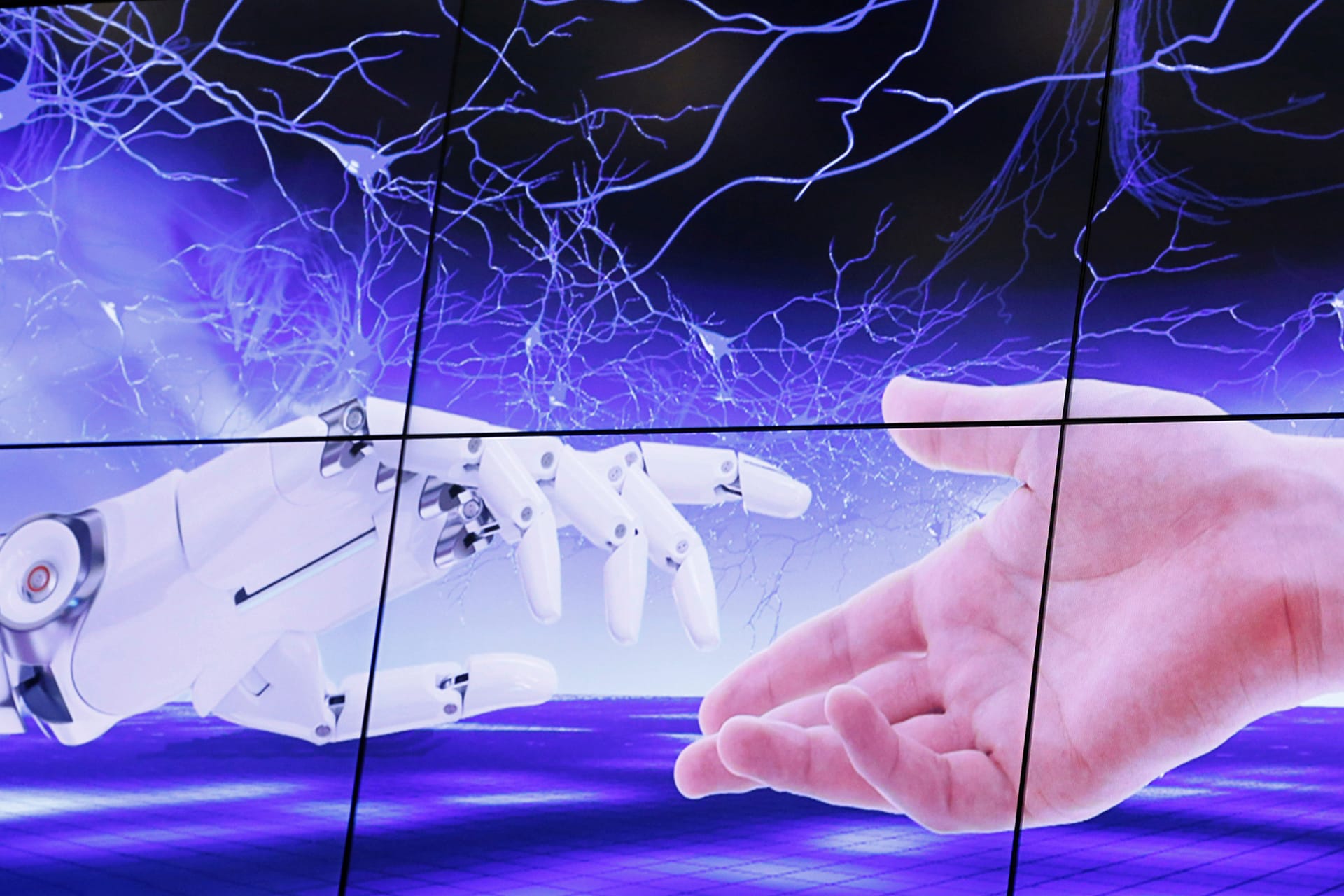 <p>An illustration shows a robot hand and a human one moving toward each other during the “AI for Good” Global Summit at the International Telecommunication Union in Geneva, Switzerland, on June 7, 2017.</p>
