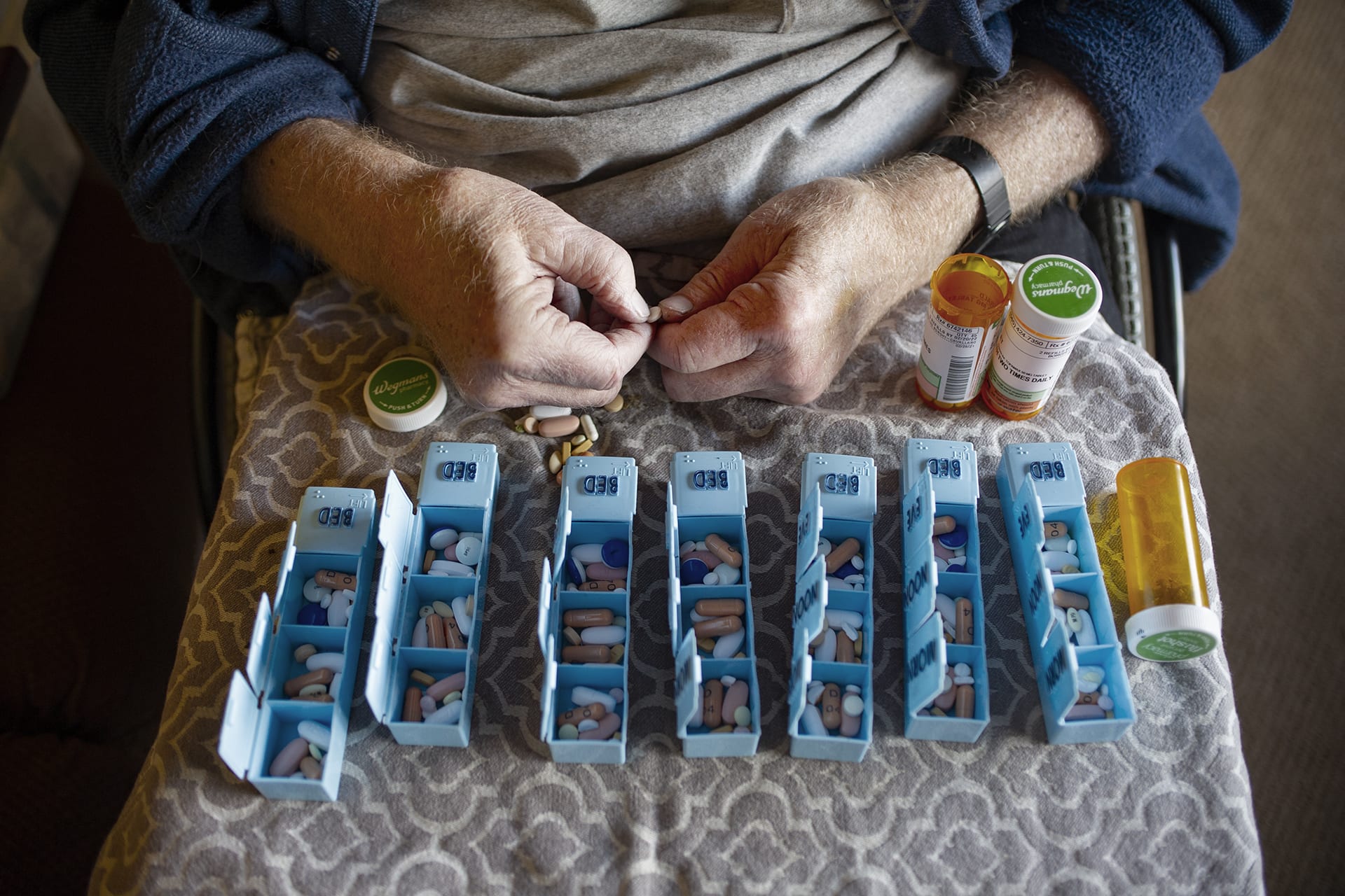 Disabled person with Multiple Sclerosis hand sorting prescription pills