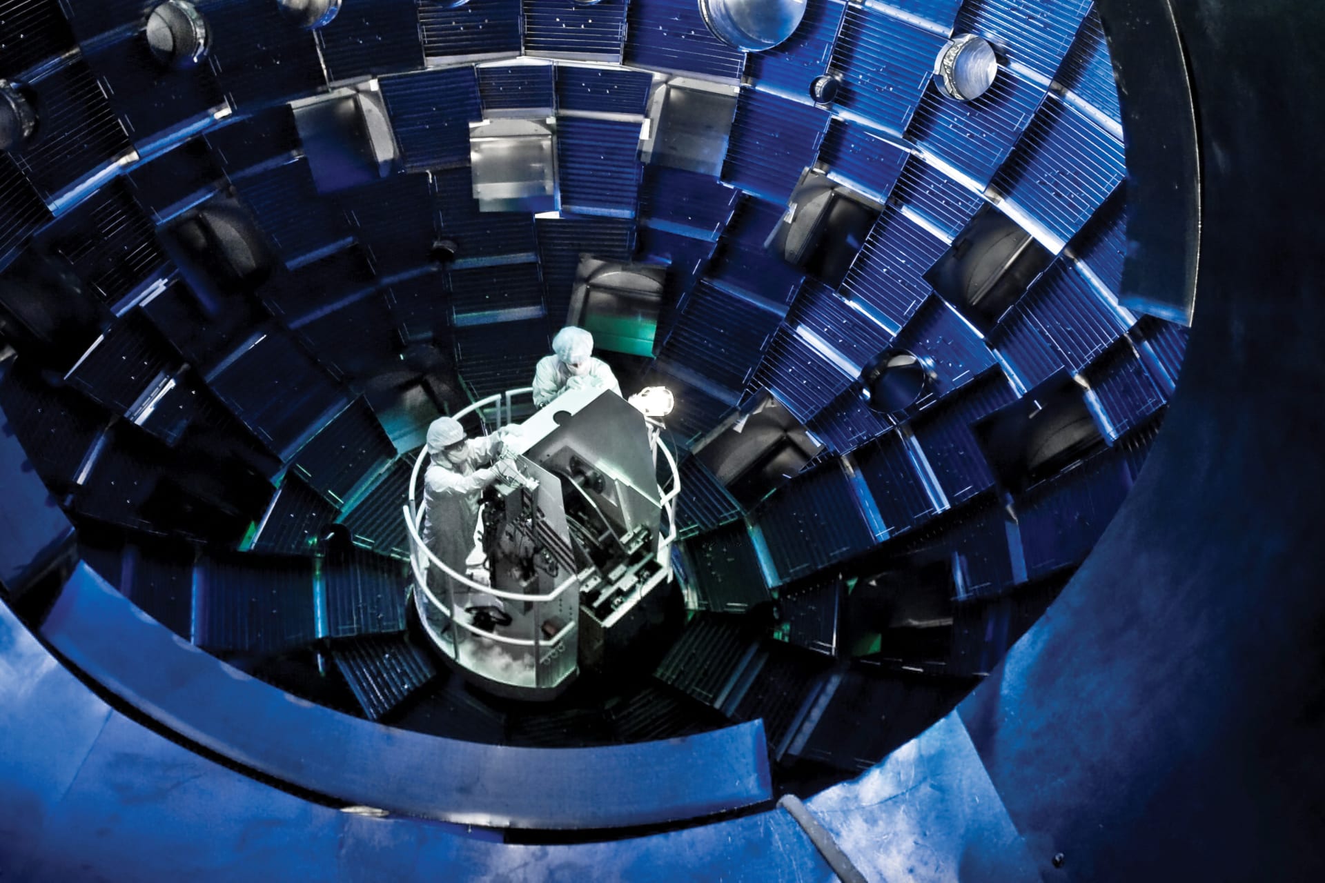 Technicians use a service system lift at Lawrence Livermore National Laboratory.