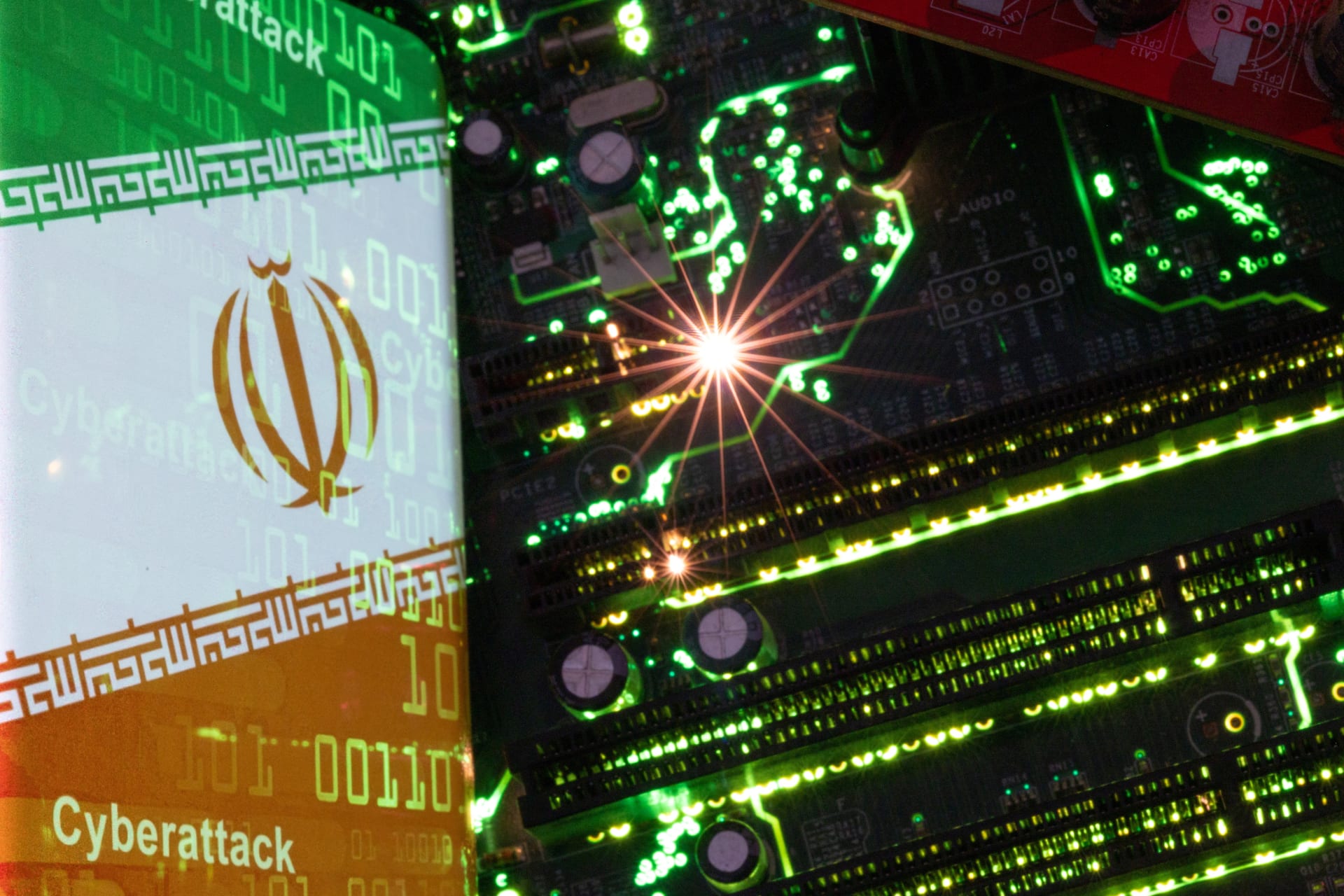 <p>A smartphone with a displayed Iranian flag with the word “Cyberattack” and binary codes over it is placed on a computer motherboard in this illustration taken February 23, 2023.</p>