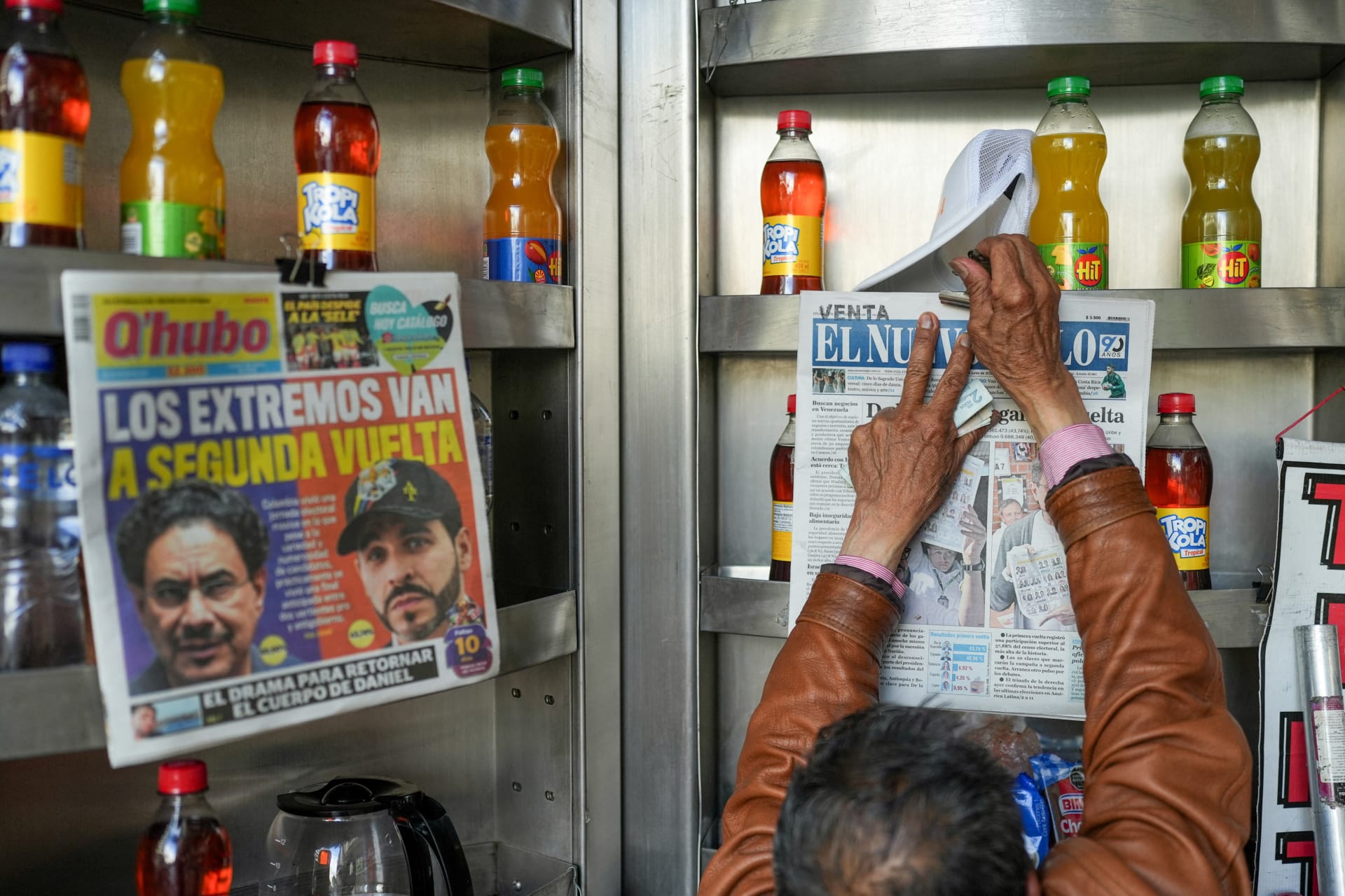 A newspaper vendor arranges a newspaper with coverage of Colombia's presidential election runoff, in Bogota, Colombia, June 1, 2026.