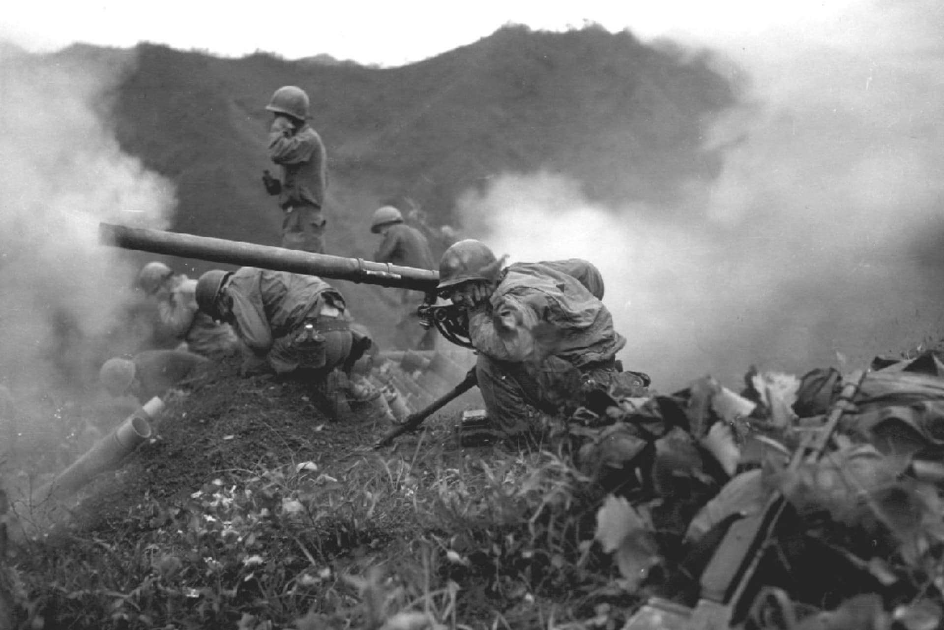 A soldier during the Korean War firing a weapon.