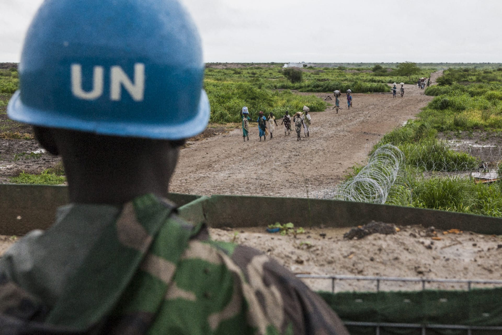 A U.N. peacekeeper observing villagers in South Sudan.