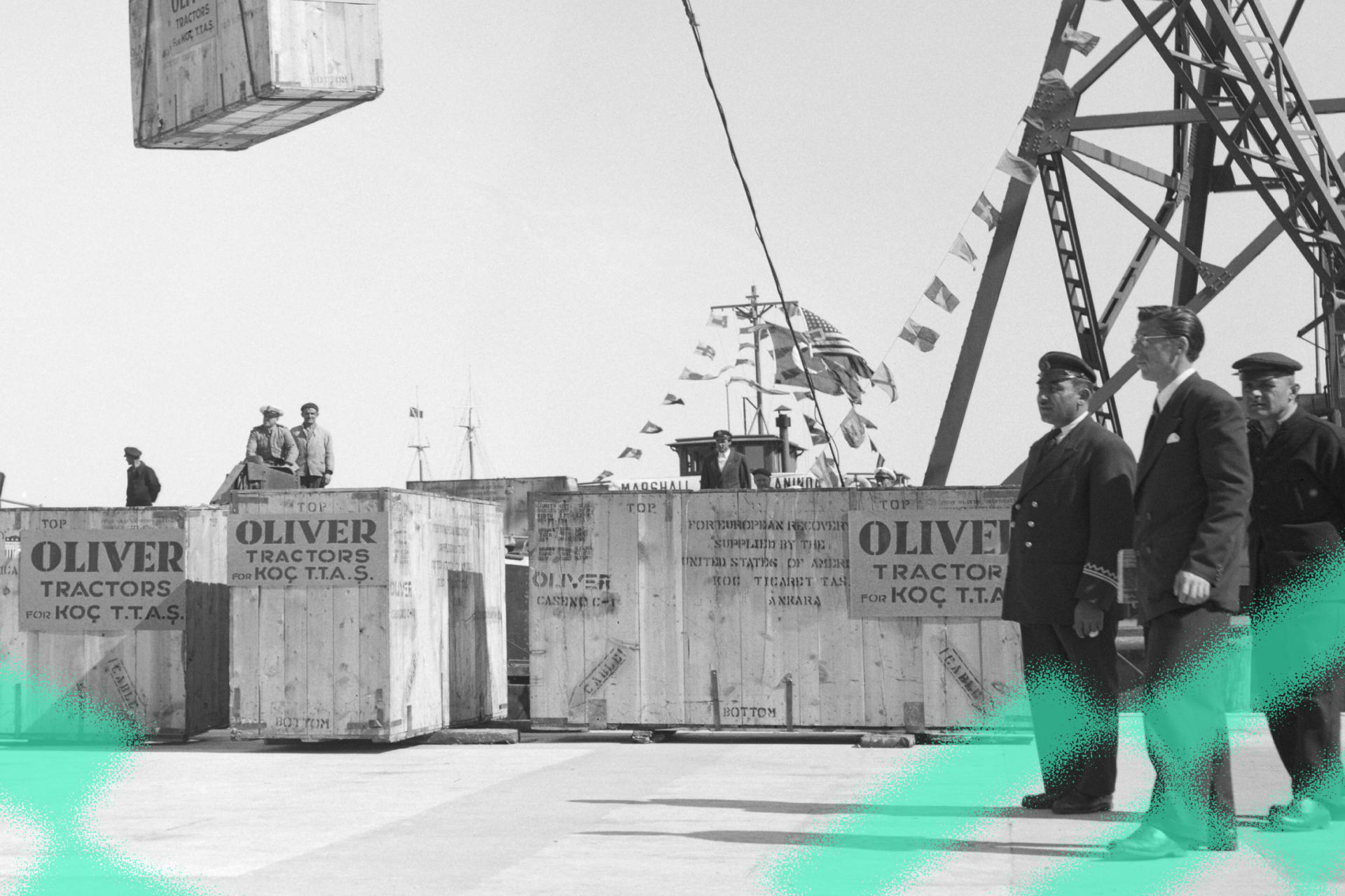 Crates of tractors are unloaded on docks after the first shipment of Marshall Plan industrial equipment reaches Istanbul.