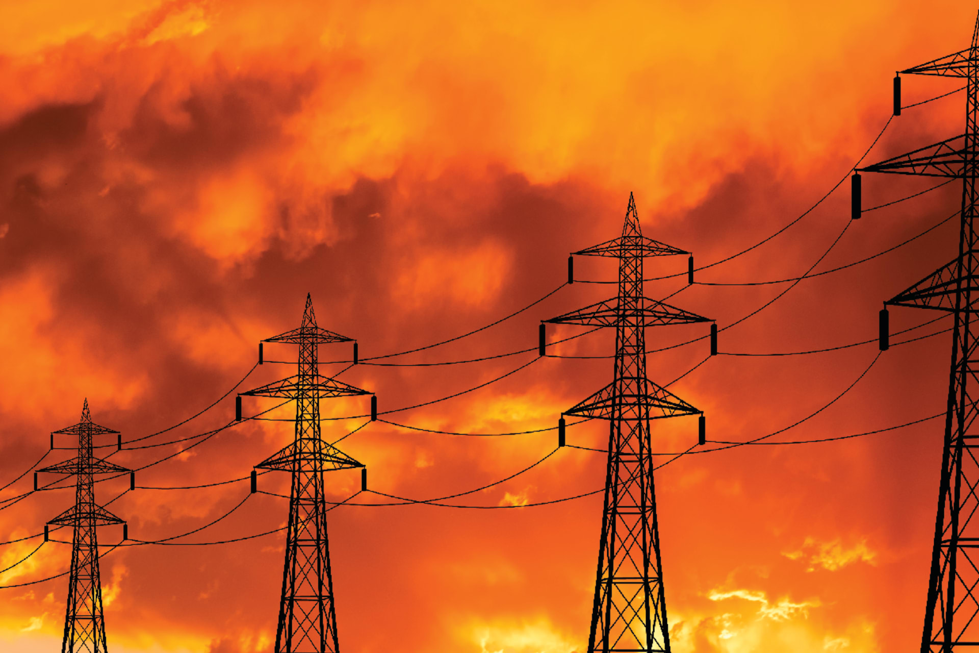 High voltage towers at sunset background. Power lines against the sky