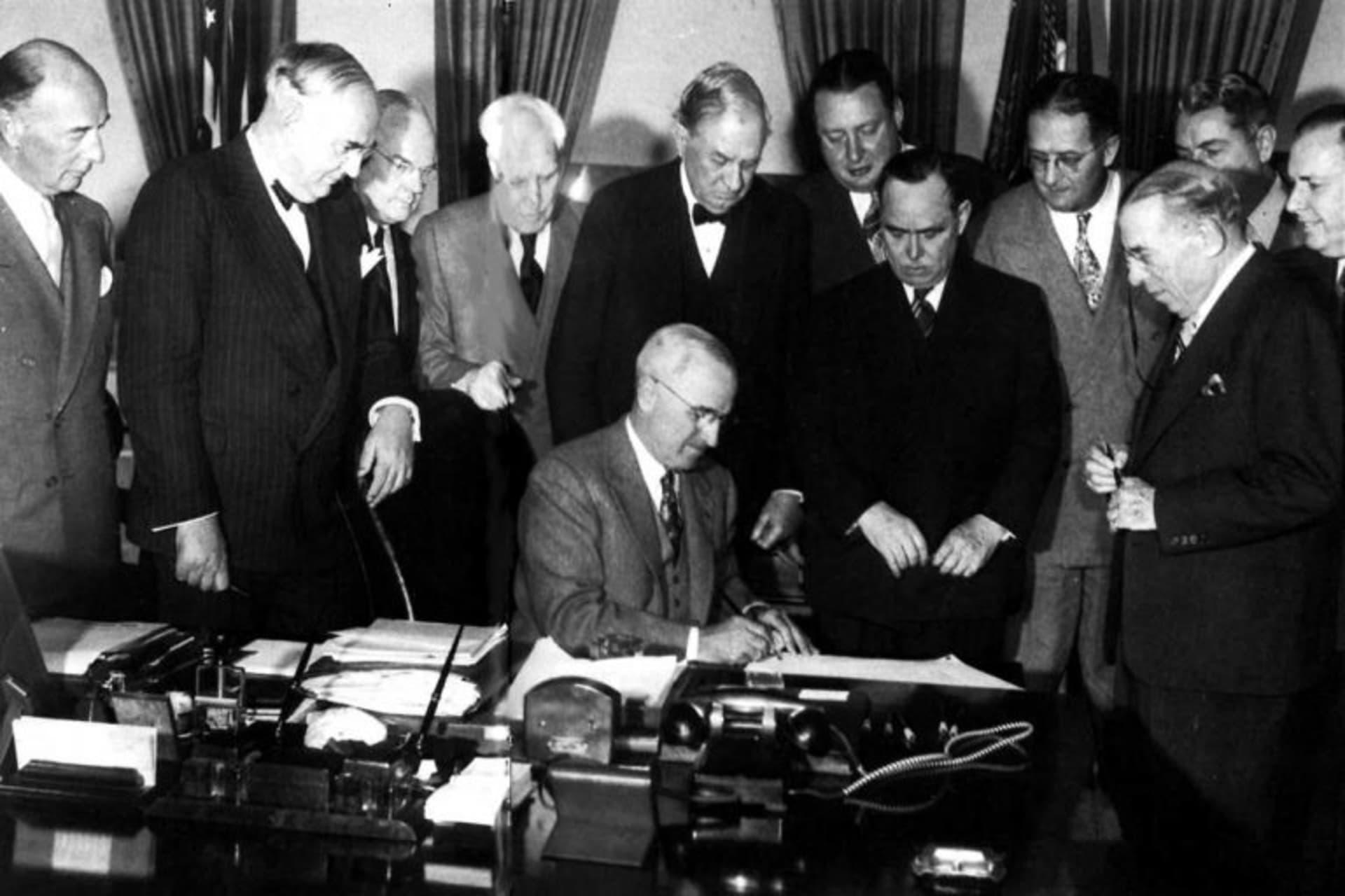 <p>President Harry S. Truman signs the Marshall Plan into law, April 3, 1948.</p>
