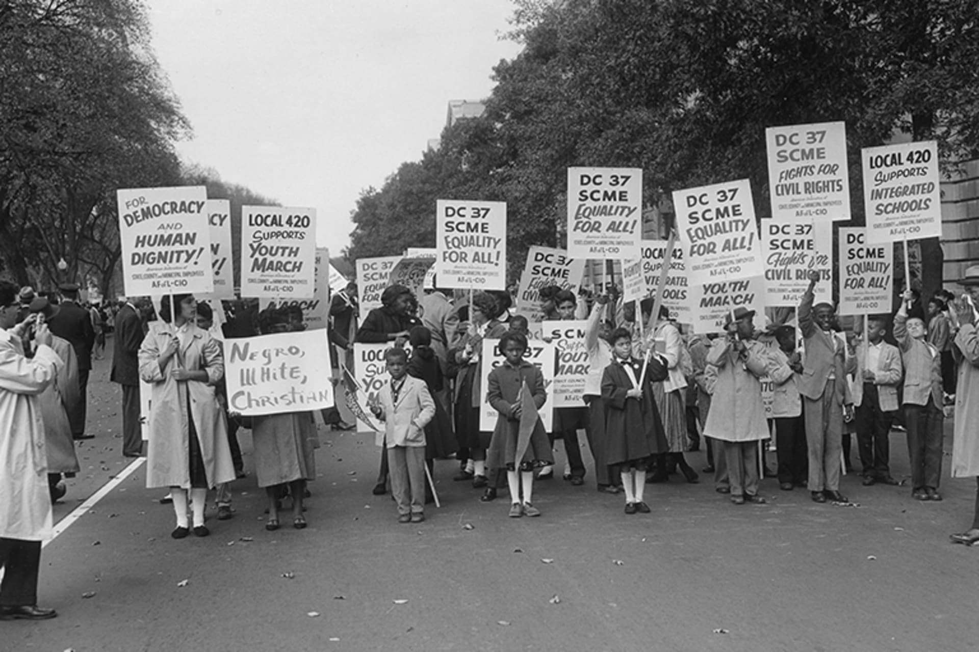 Demonstrators hold various signs at the Lincoln Memorial Youth March for Integrated Schools.