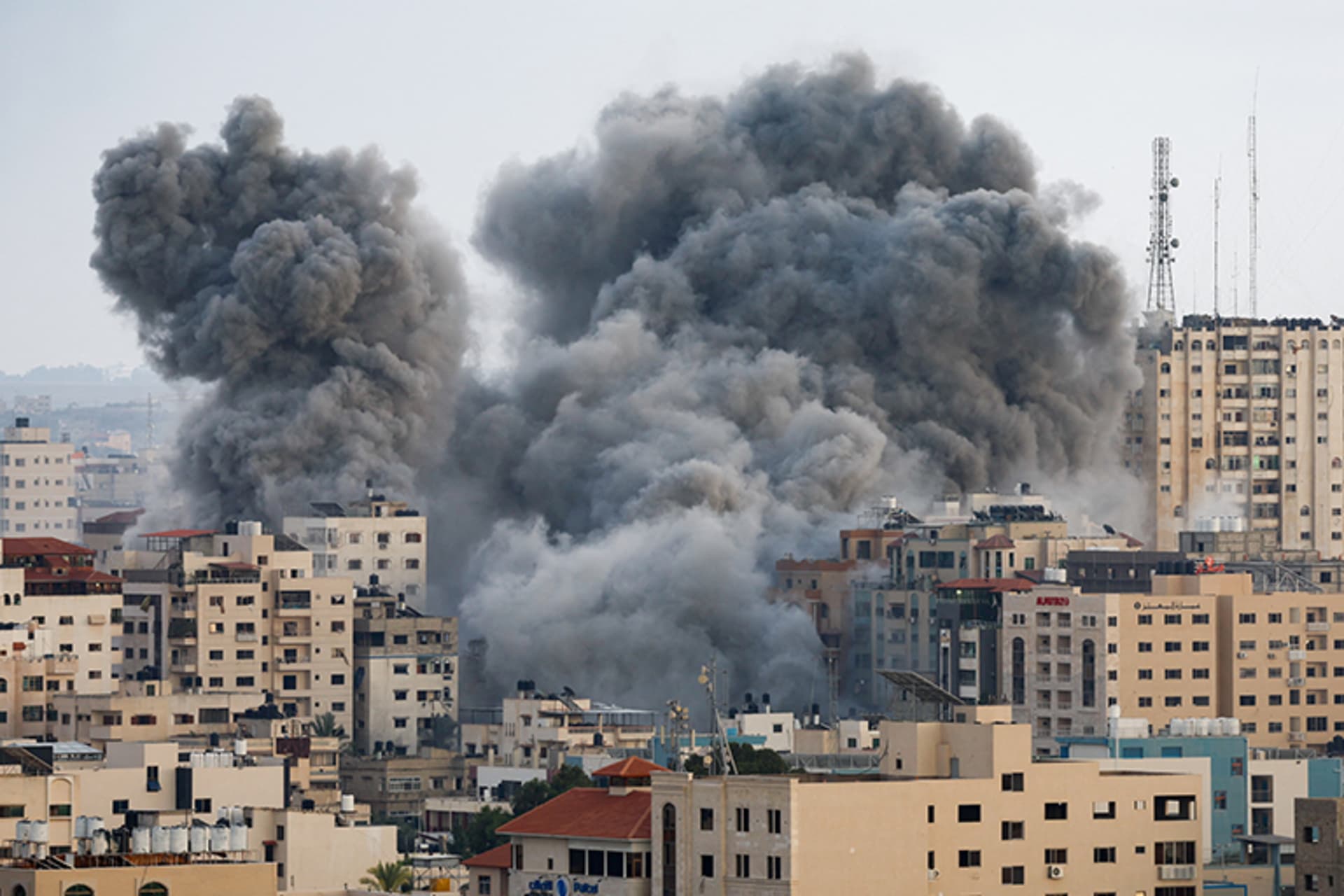 Smoke rises from buildings in Gaza following Israeli strikes.