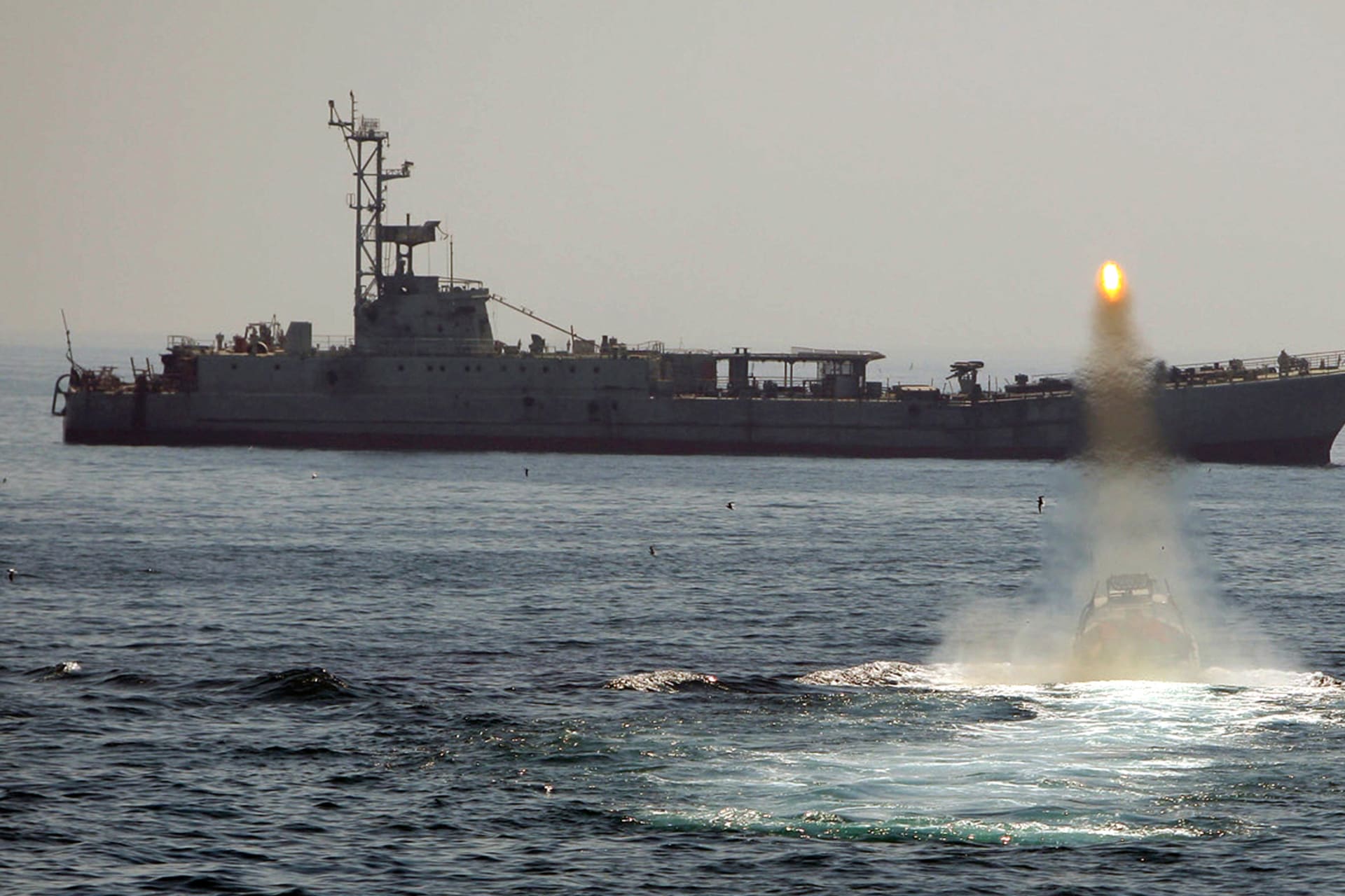An Iranian warship and speed boats take part in a naval war game in the Persian Gulf and the Strait of Hormuz, southern Iran.