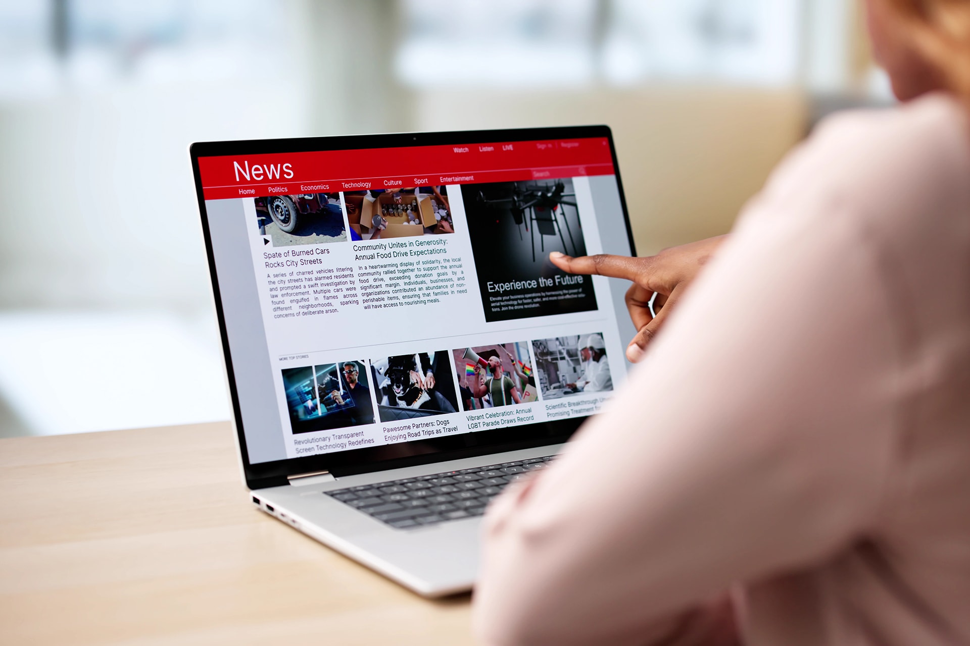 Woman Reading Newspaper On Computer