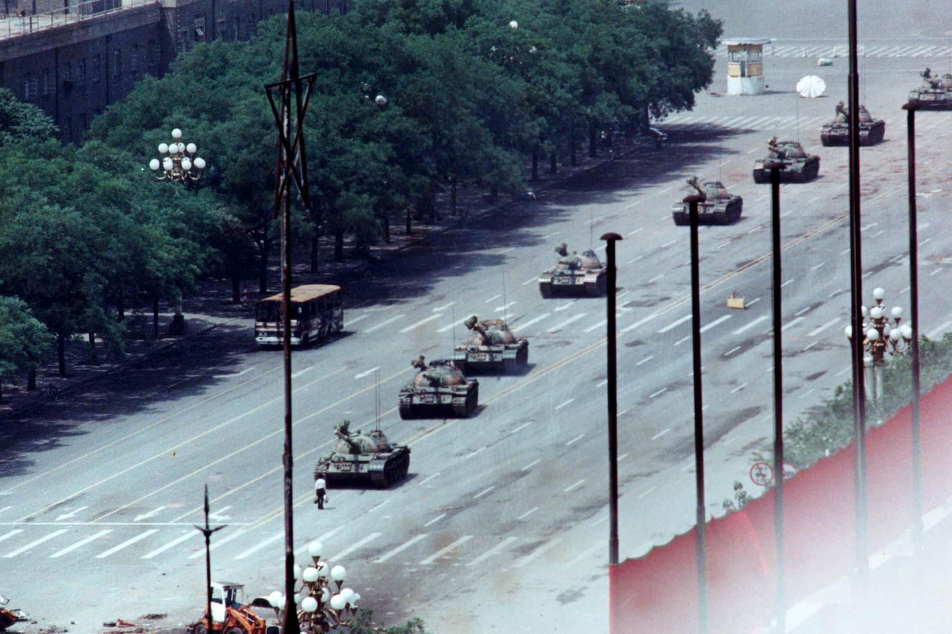 File photo shows a man standing passively to block a column of army tanks on Changan Avenue east of Tiananmen Square in Beijing