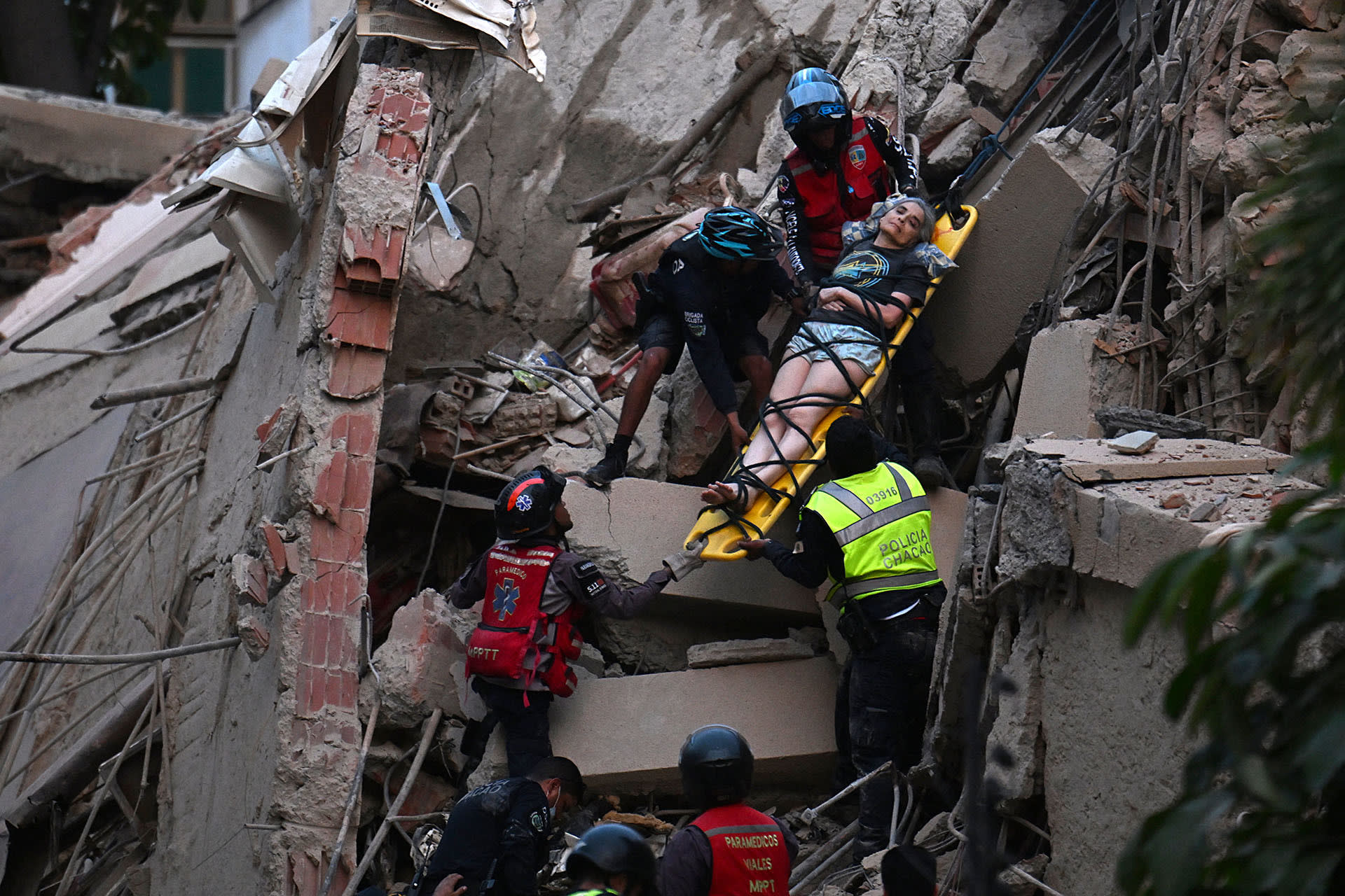 Rescue workers carry a person on a stretcher out of a collapsed building following an earthquake in Caracas on June 24, 2026.