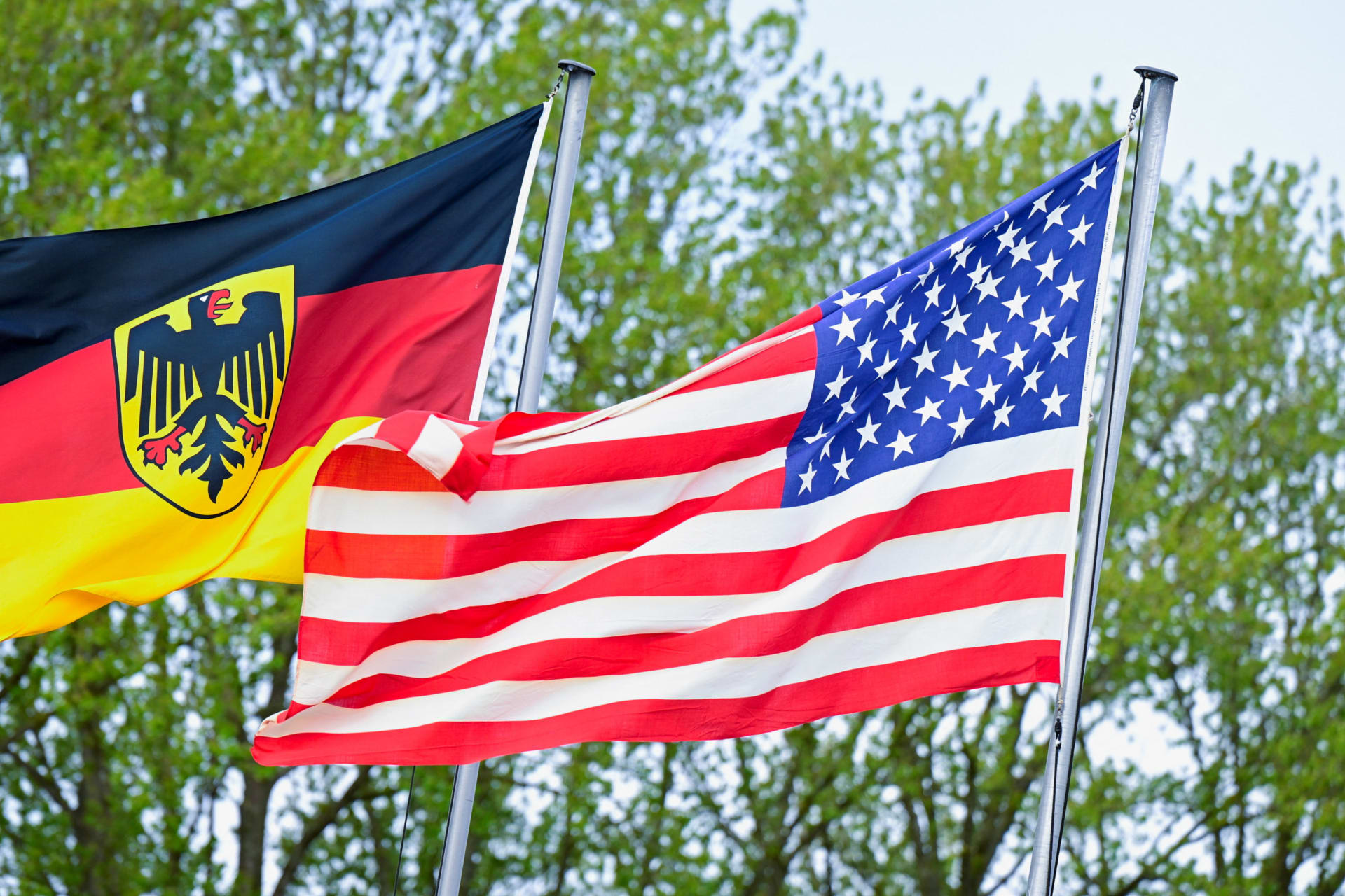 The German flag featuring the Federal Eagle and the U.S. flag are pictured at the German Navy base in Kiel