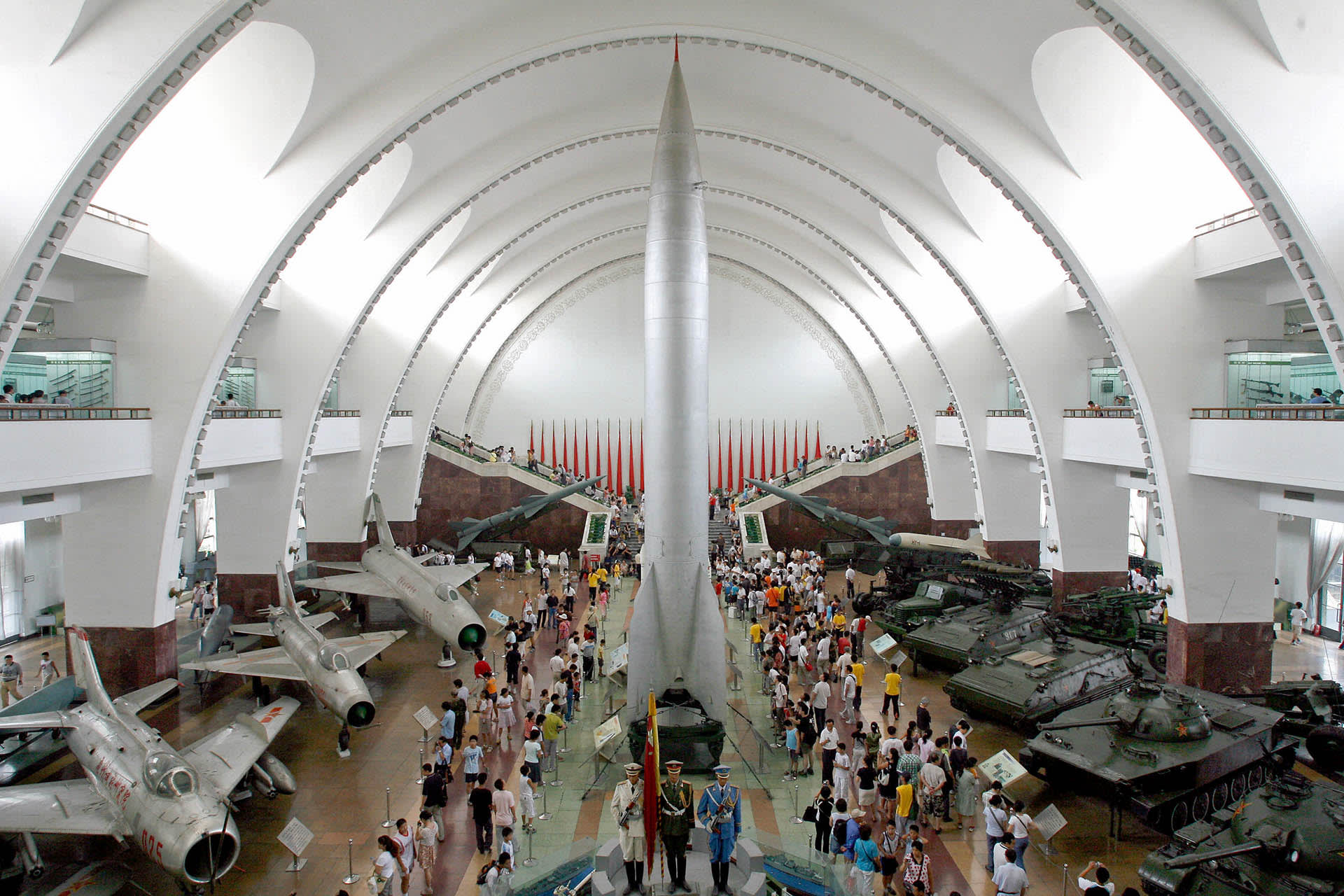 Visitors walk past China's first nuclear
