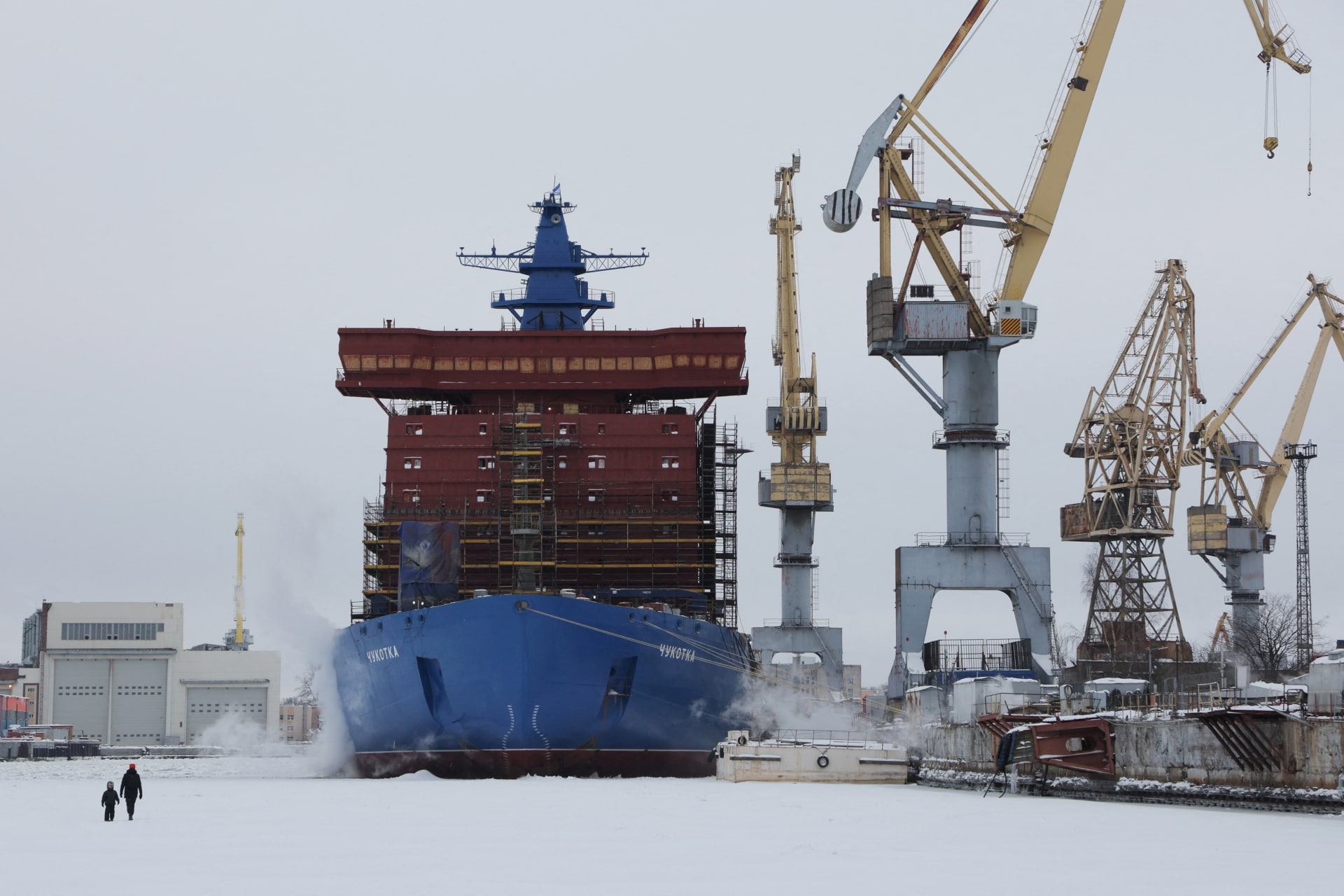 People walk on the ice-covered Neva River near the nuclear-powered icebreaker Chukotka moored at the Baltic Shipyard in Saint Petersburg, Russia February 8, 2026. REUTERS/Anton Vaganov