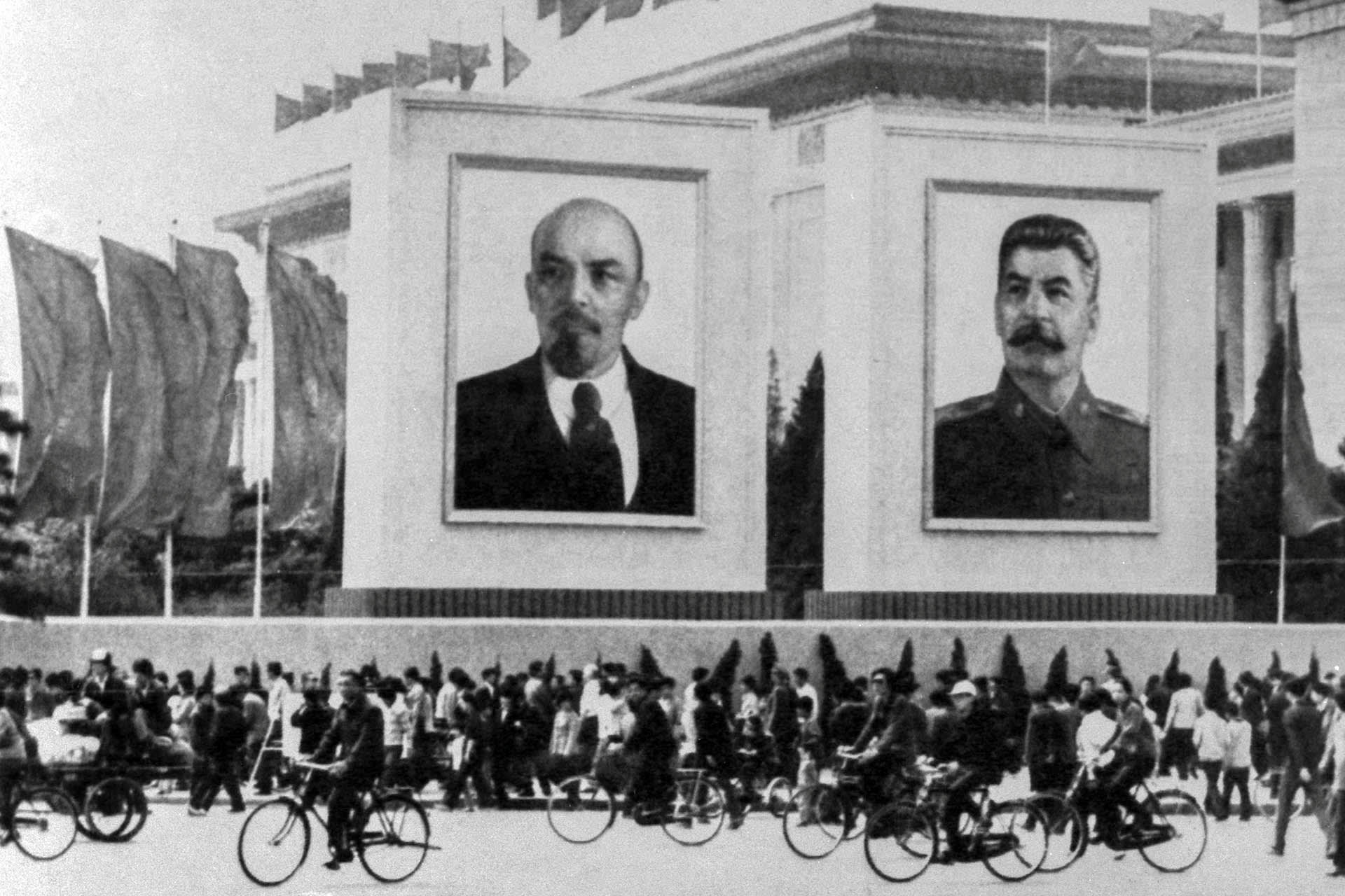 Huge pictures of Communist heroes Lenin and Stalin hang in front of the flag-bedecked Great Hall of the People during the annual May Day parade in Moscow