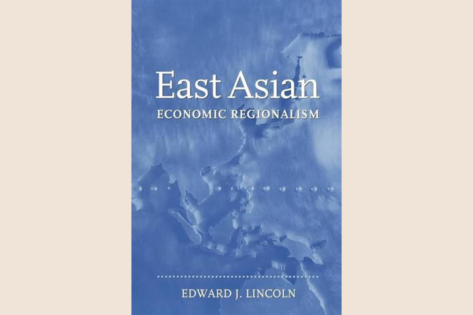 A light blue book cover with a map of East Asia in the background with text that reads, "East Asian Economic Regionalism".