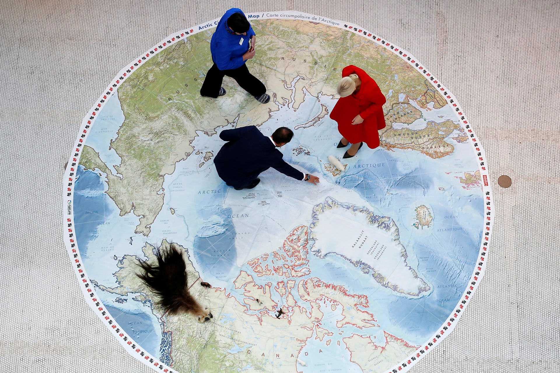 Norway's Crown Prince Haakon and Crown Princess Mette-Marit look at an Arctic map at the Canadian Museum of Nature in Ottawa