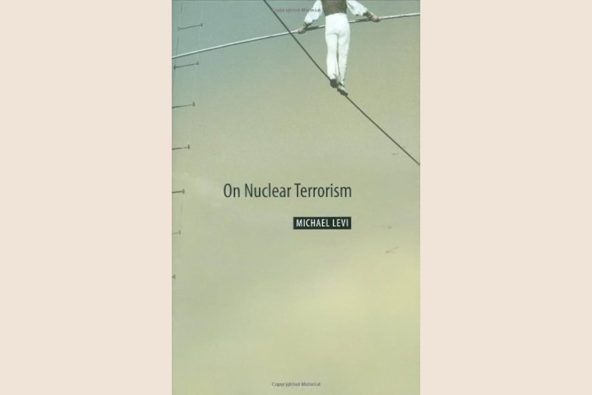 A book cover showing a person walking a tightrope and holding a rod in their hands. The text reads, "On Nuclear Terrorism".