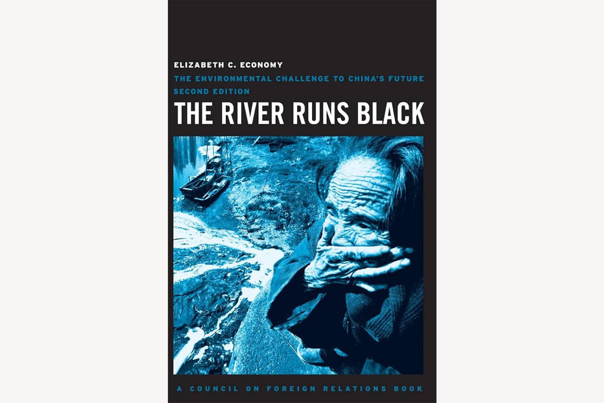 A book cover with a photograph of someone covering their mouth in a horrified manner next to a river. The photo has a dark, blueish filter over it. The text reads, "The River Runs Black: The Environmental Challenge to China's Future".