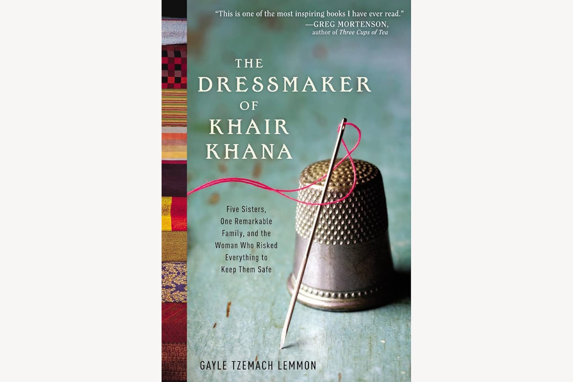 A book cover showing a thimble, needle, and thread with text that reads, "The Dressmaker of Khair Khana: Five Sisters, One Remarkable Family, and the Woman Who Risked Everything to Keep Them Safe".