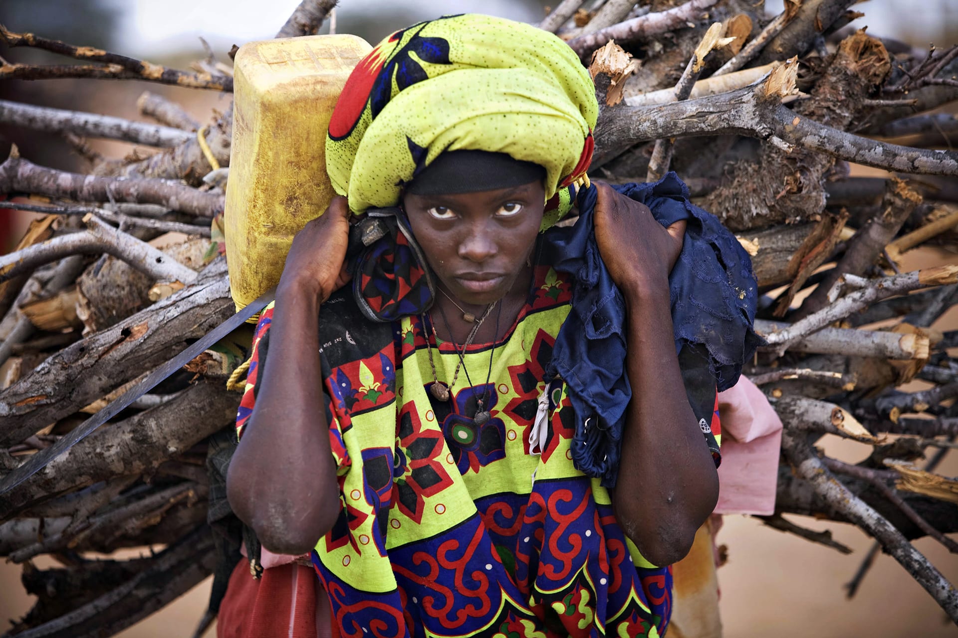 A Somali refugee woman adjusts carries firewood at Dagahaley camp in Dadaab in Kenya's northeastern province