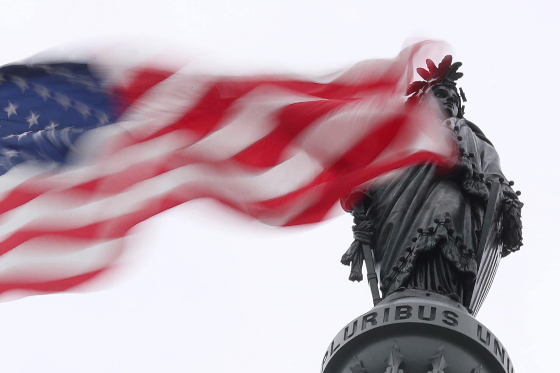 The U.S. flag flies near the Statue of Freedom atop the U.S. Capitol in Washington
