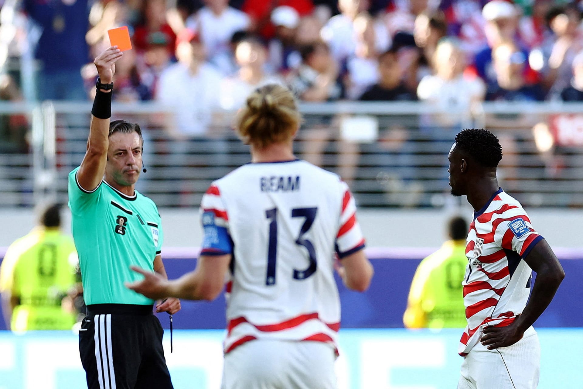 Folarin Balogun of the U.S. Men's National Team is shown a red card by referee Raphael Claus during a FIFA World Cup match against Bosnia and Herzegovina in San Francisco Bay Area Stadium, Santa Clara, California.