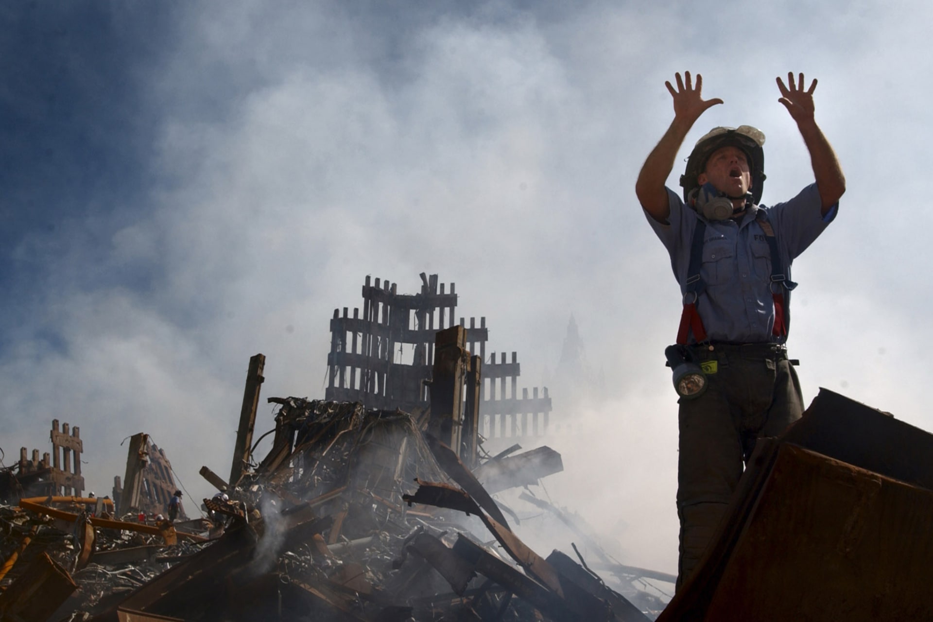 A New York City fireman calls for more rescue workers to make their way into the rubble of the World Trade Center September 15, 2001