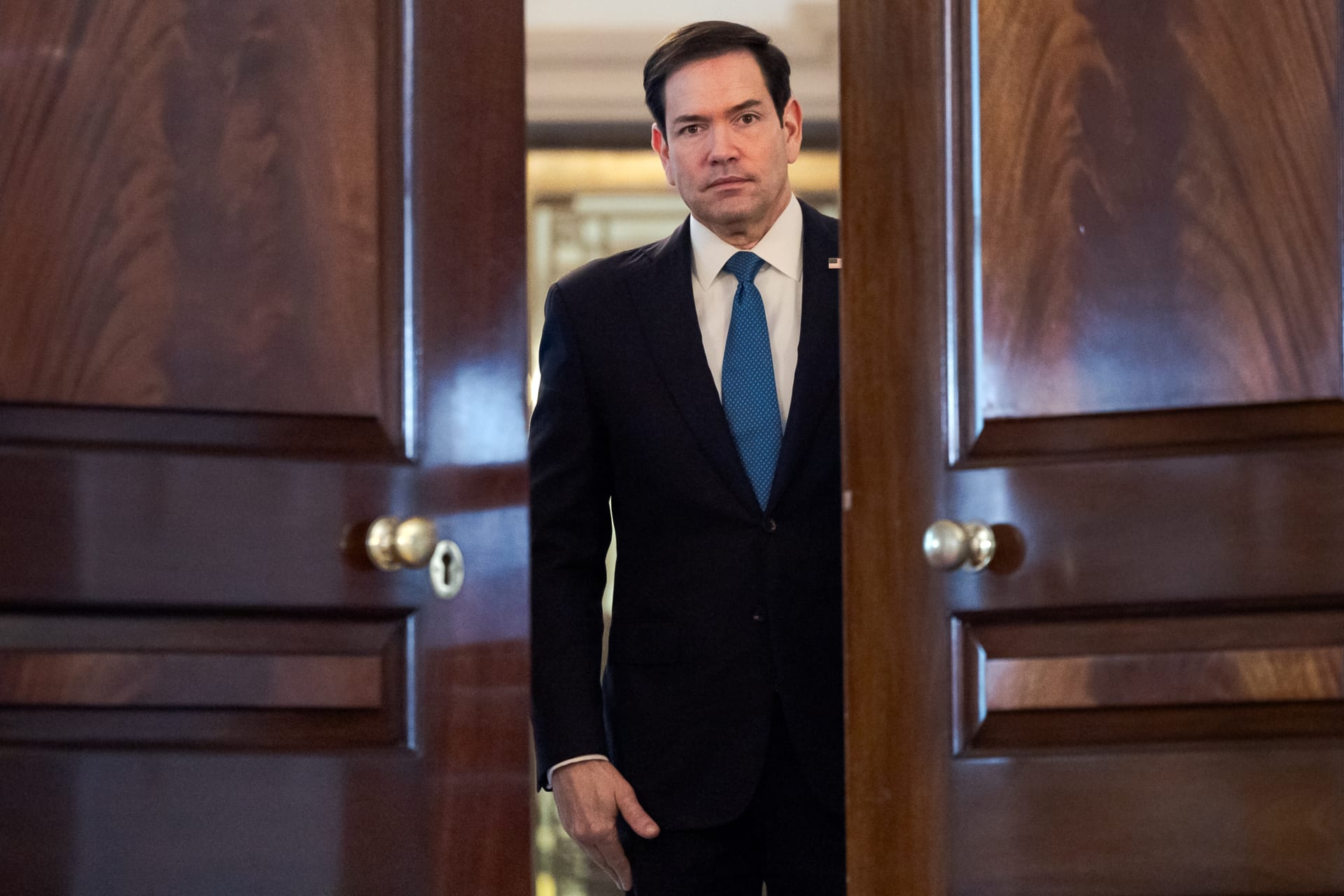 Secretary Of State Rubio is framed by an open wooden door at the State Dept.