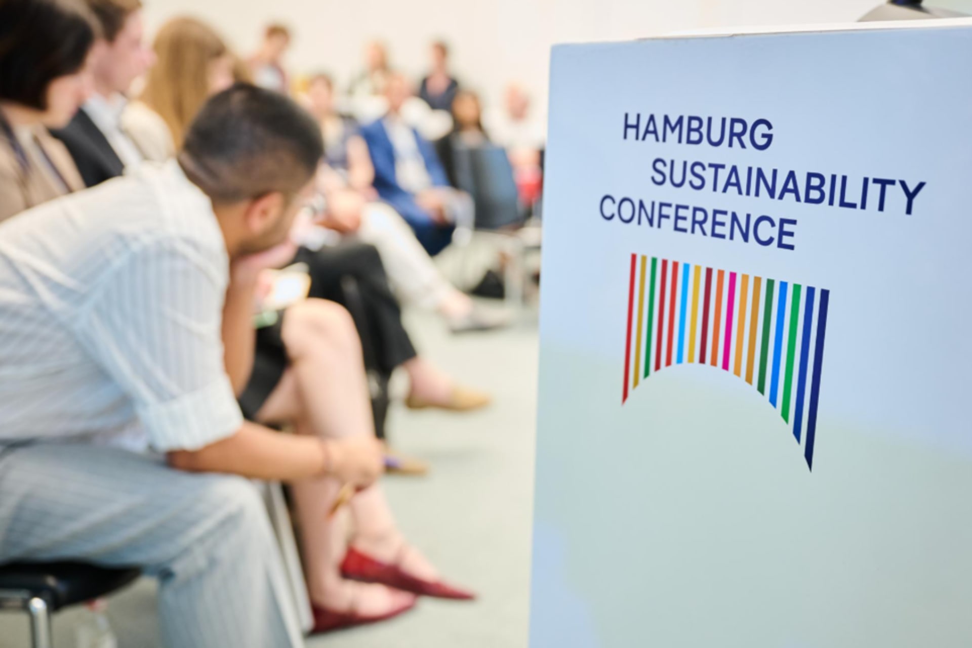 A photo of a Hamburg Sustainability Conference event with a sign.