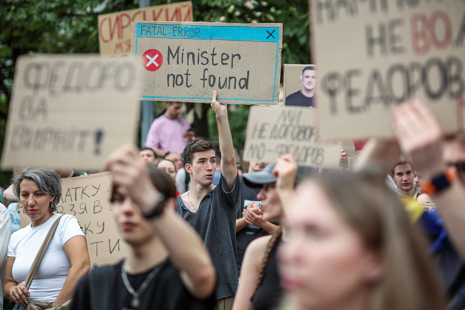 Participants hold signs during a rally to protest against Ukrainian President Volodymyr Zelenskyy's decision to replace Mykhailo Fedorov as Defense Minister, amid Russia's attack on Ukraine, in Kyiv, Ukraine, on July 24, 2026.