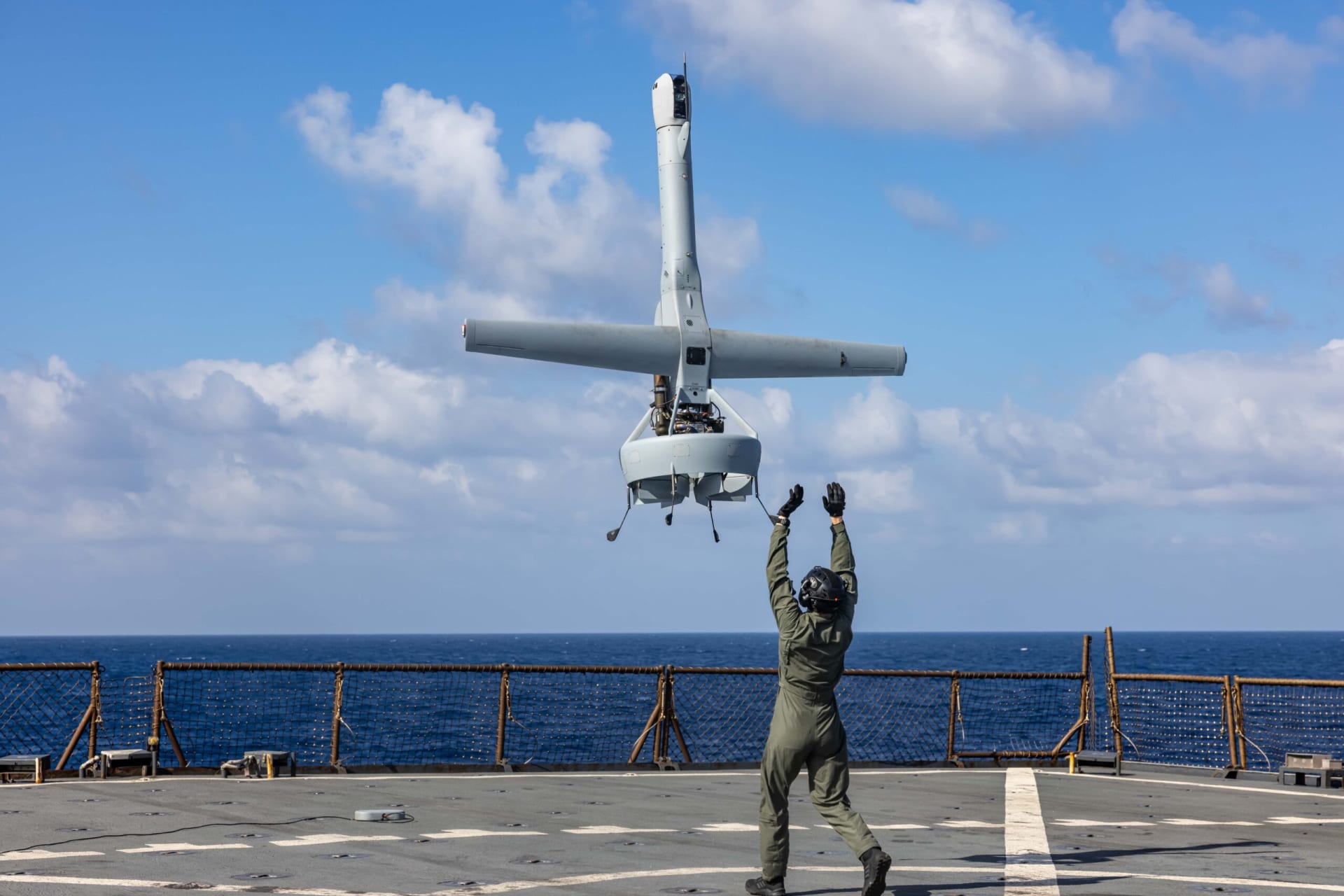 A U.S. Marine launches a VBAT on the deck of the USS Carter Hall.
