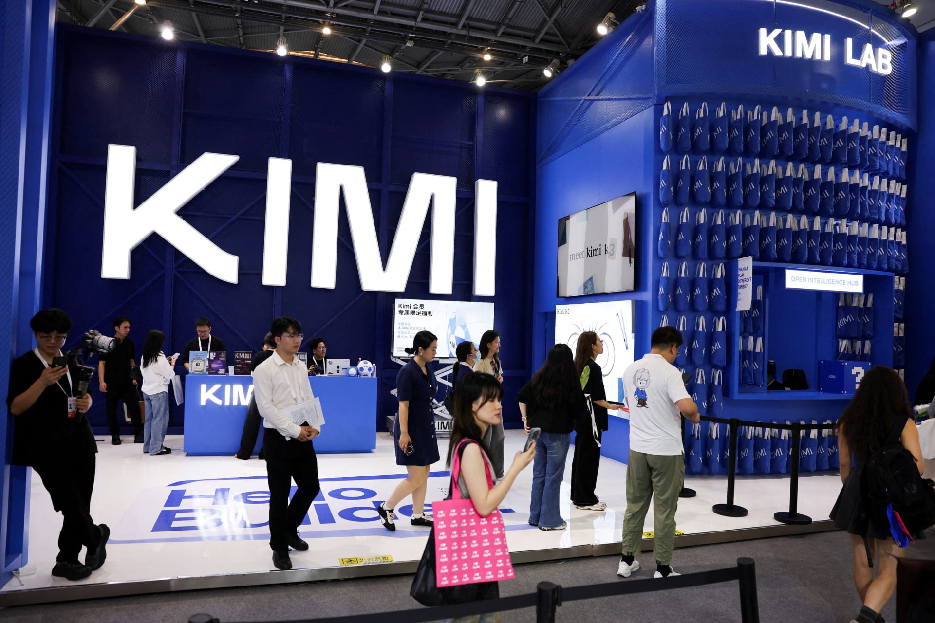 <p>People walk past the Moonshot booth promoting its Kimi K3 AI model, during the World Artificial Intelligence Conference  in Shanghai, China, July 17, 2026. </p>
