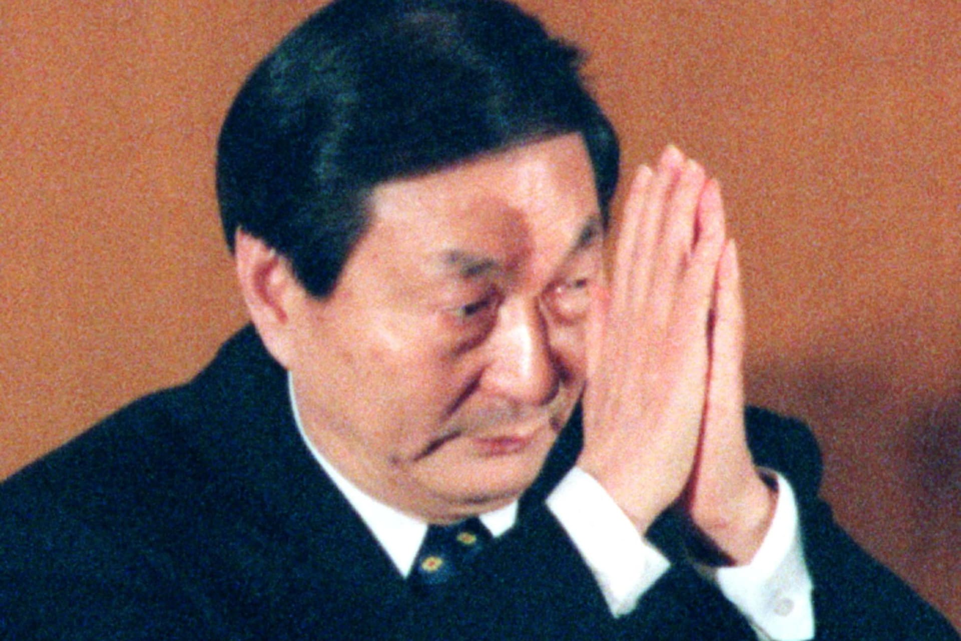 FILE PHOTO: Zhu Rongji Clasps His Hands To acknowledge applause in Beijing