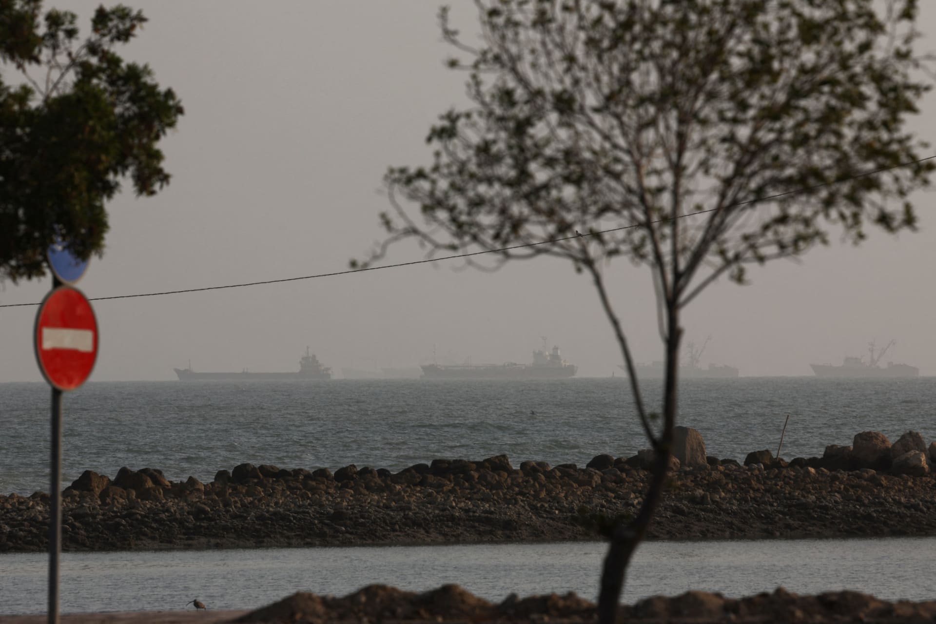 Vessels in the Strait of Hormuz are visible near the beach of Bandar Abbas, Iran, August 26, 2026.