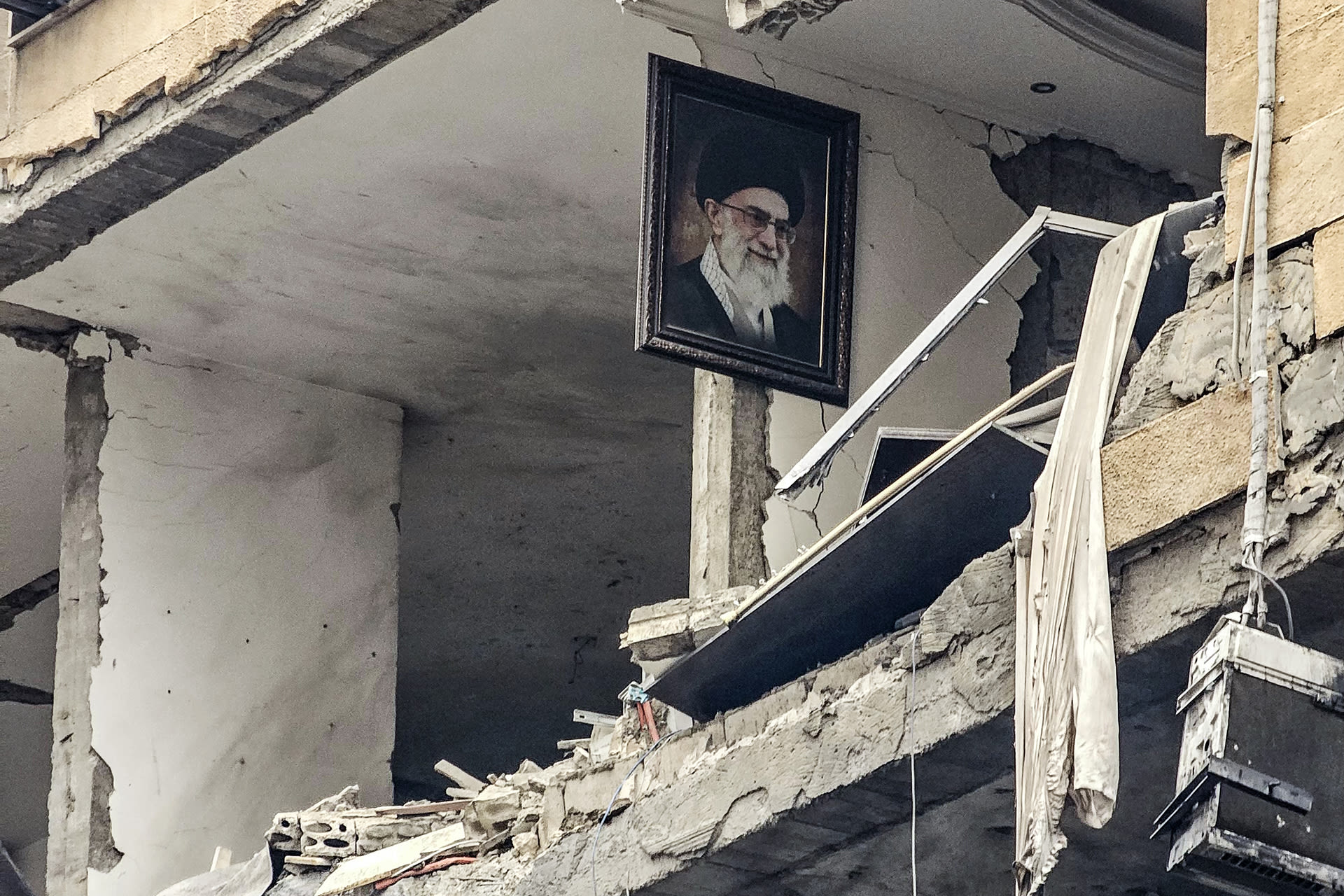 <p>A portrait of Iran’s late Supreme Leader Ayatollah Ali Khamenei, who was killed in the opening salvo of the Iran war on February 28, is seen hanging on the wall of a destroyed building in Haret Hreik, Lebanon, on March 15, 2026.</p>
