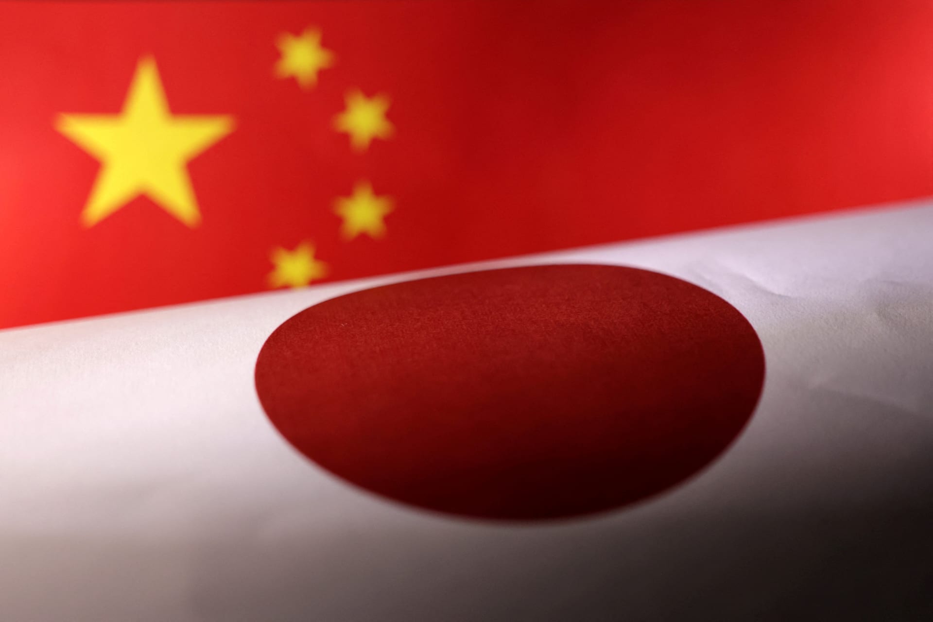 <p>Printed Chinese and Japanese flags are seen in this illustration</p>