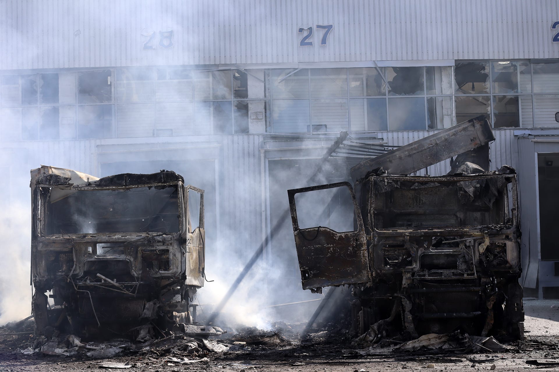 Burned-out trucks stand near a food warehouse hit by Russian drones on September 2, 2026, in Kyiv, Ukraine.