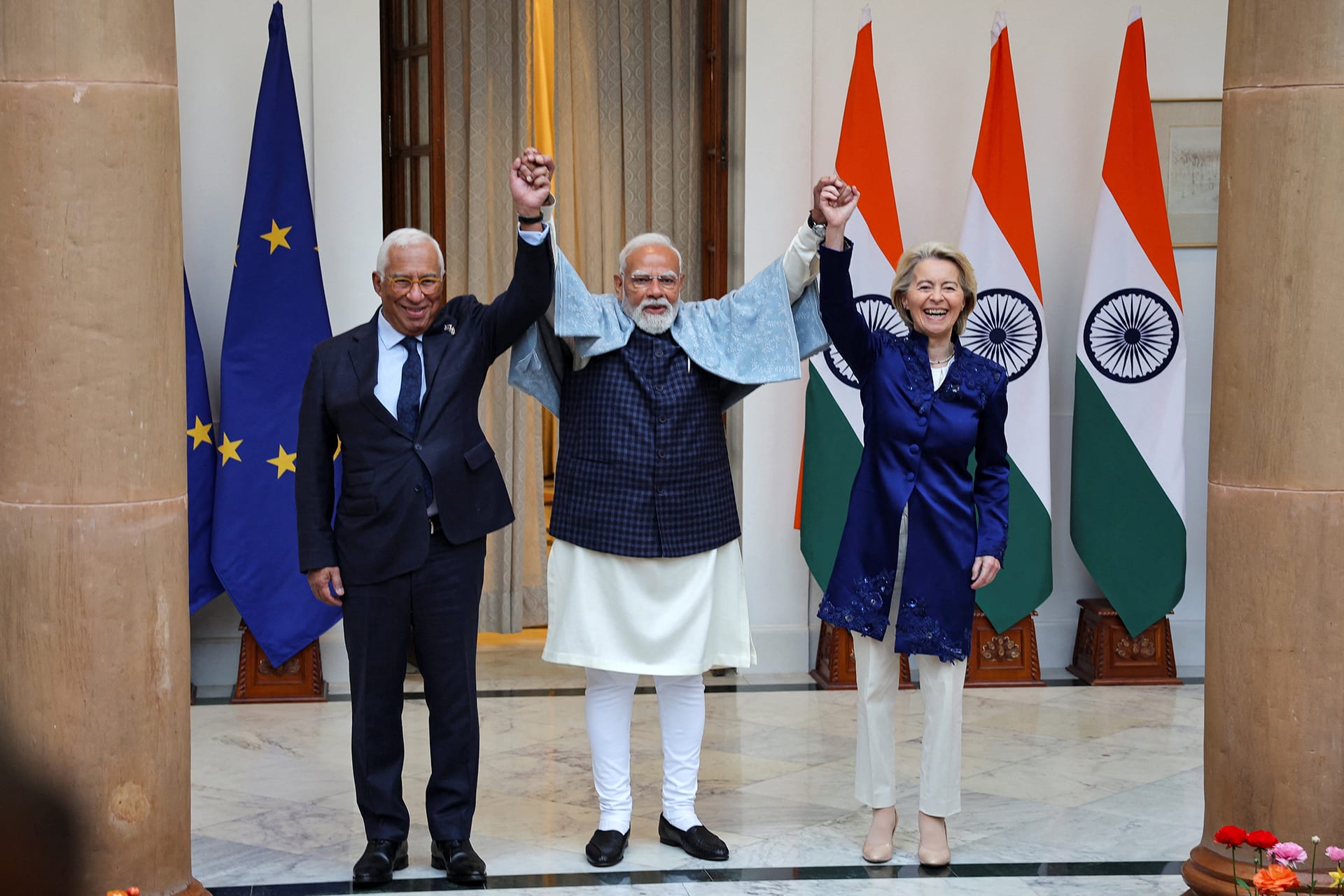 Antonio Costa, Narendra Modi, and Ursula von der Leyen pose before EU and Indian flags.