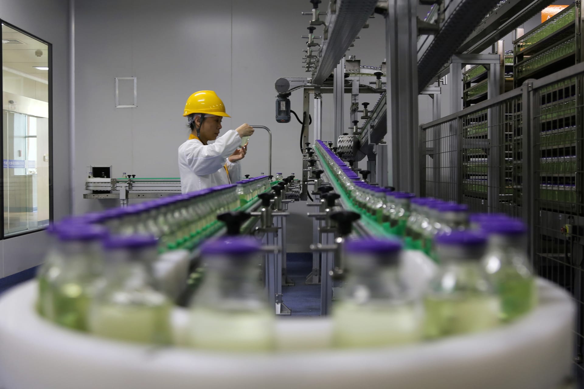 <p>An employee works on a drug-manufacturing production line in Jiangsu Province, China, in 2019.</p>