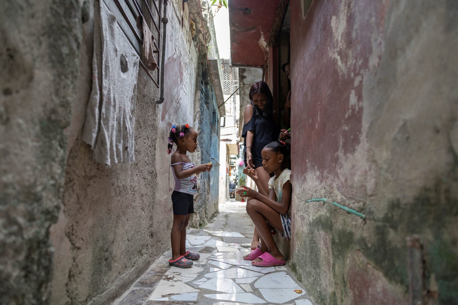 Girls gather in a narrow passageway between homes, as conditions deteriorate in Cuba amid a US-imposed oil blockade that has contributed to fuel shortages and prolonged power cuts, after US President Donald Trump said his administration was seeking a fundamental change in the situation in Cuba, in Havana, Cuba, September 22, 2026.