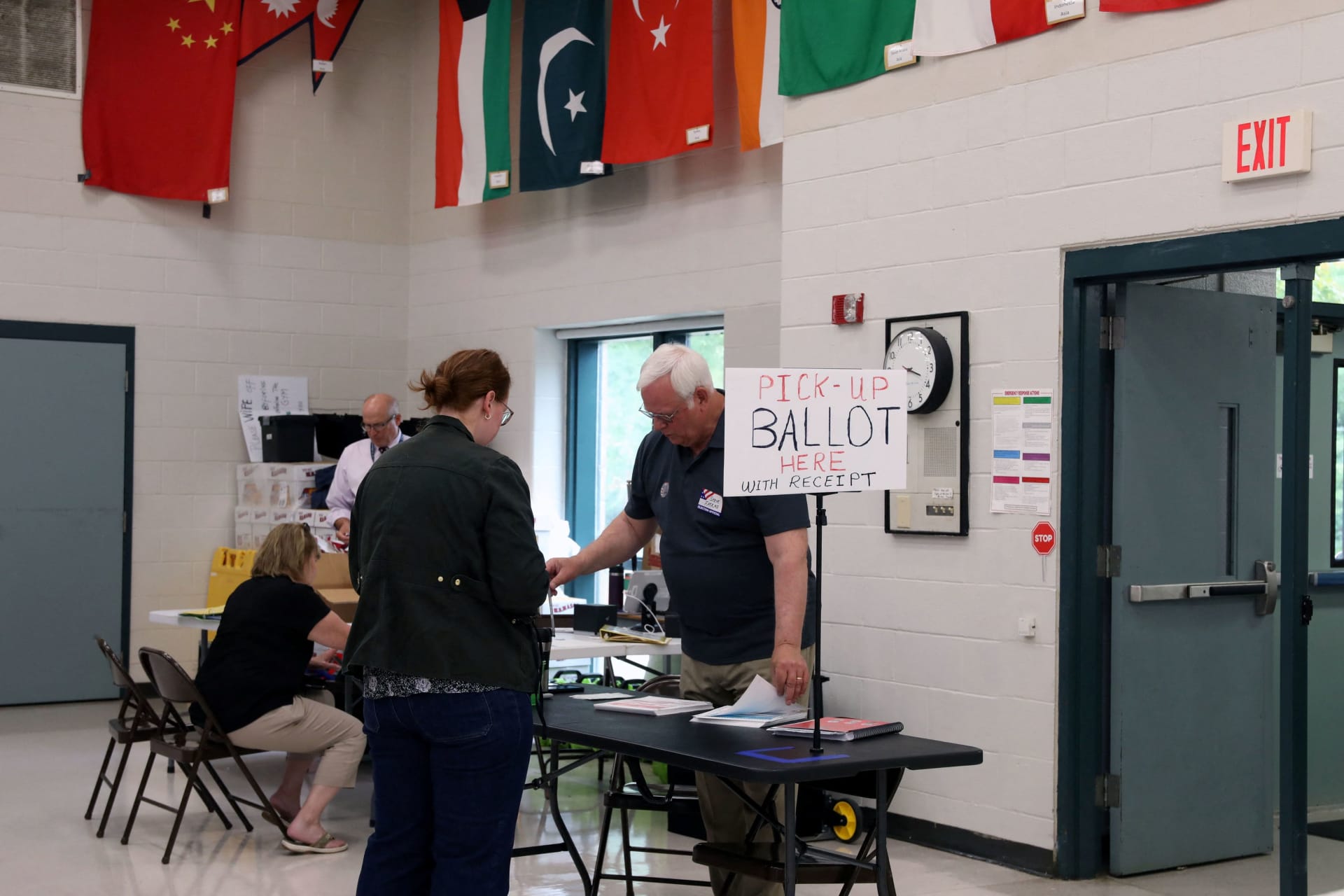 A voter collects her ballot at a polling station during the New Hampshire State Primary Election in Nashua, New Hampshire, U.S., September 8, 2026.