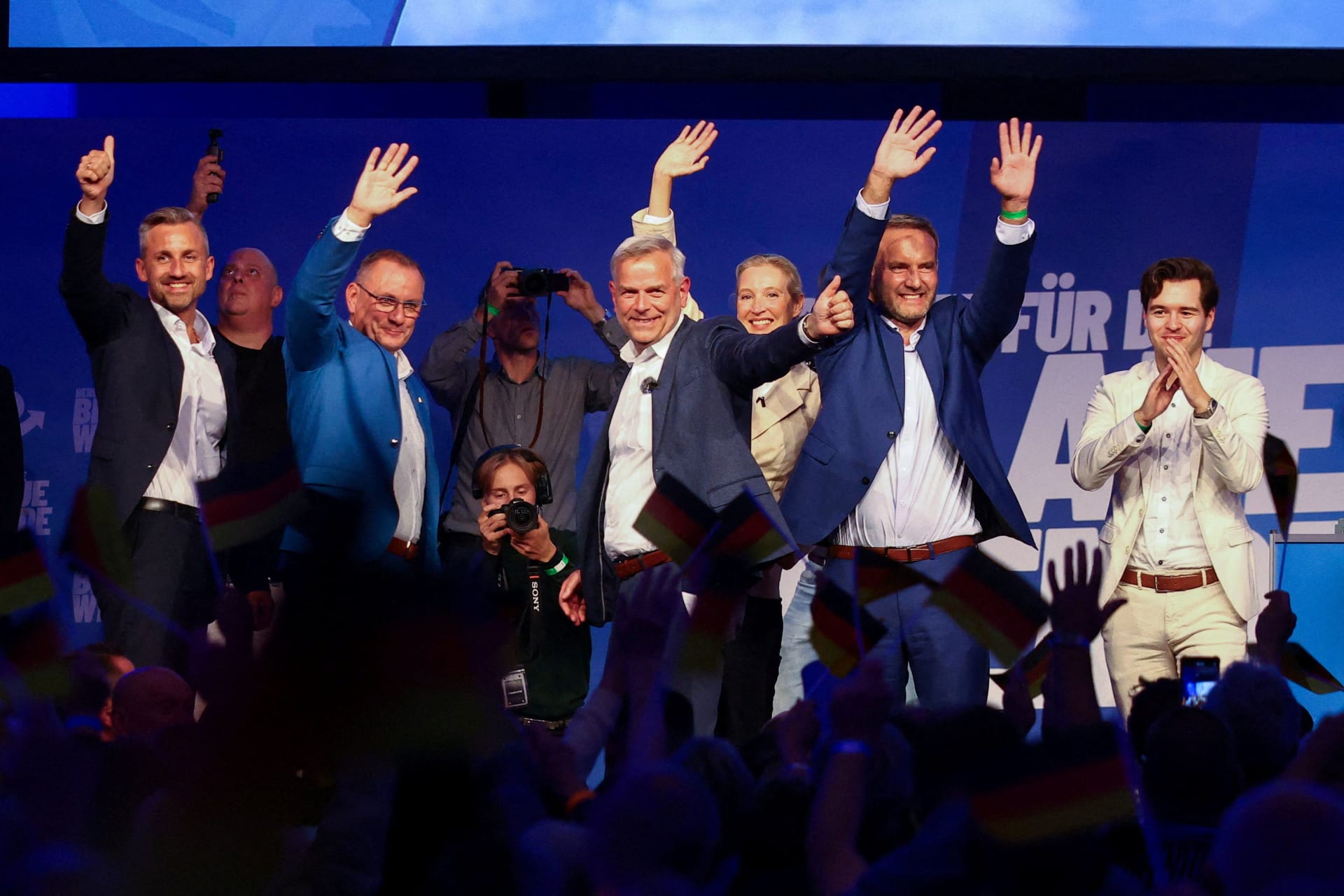 AfD co-leader Alice Weidel, AfD co-leader Tino Chrupalla, AfD candidate for state premier Leif-Erik Holm, and AfD top candidate Ulrich Siegmund gesture on stage during a campaign event ahead of the Mecklenburg-Western Pomerania state election in Neubrandenburg, Germany, September 18, 2026.