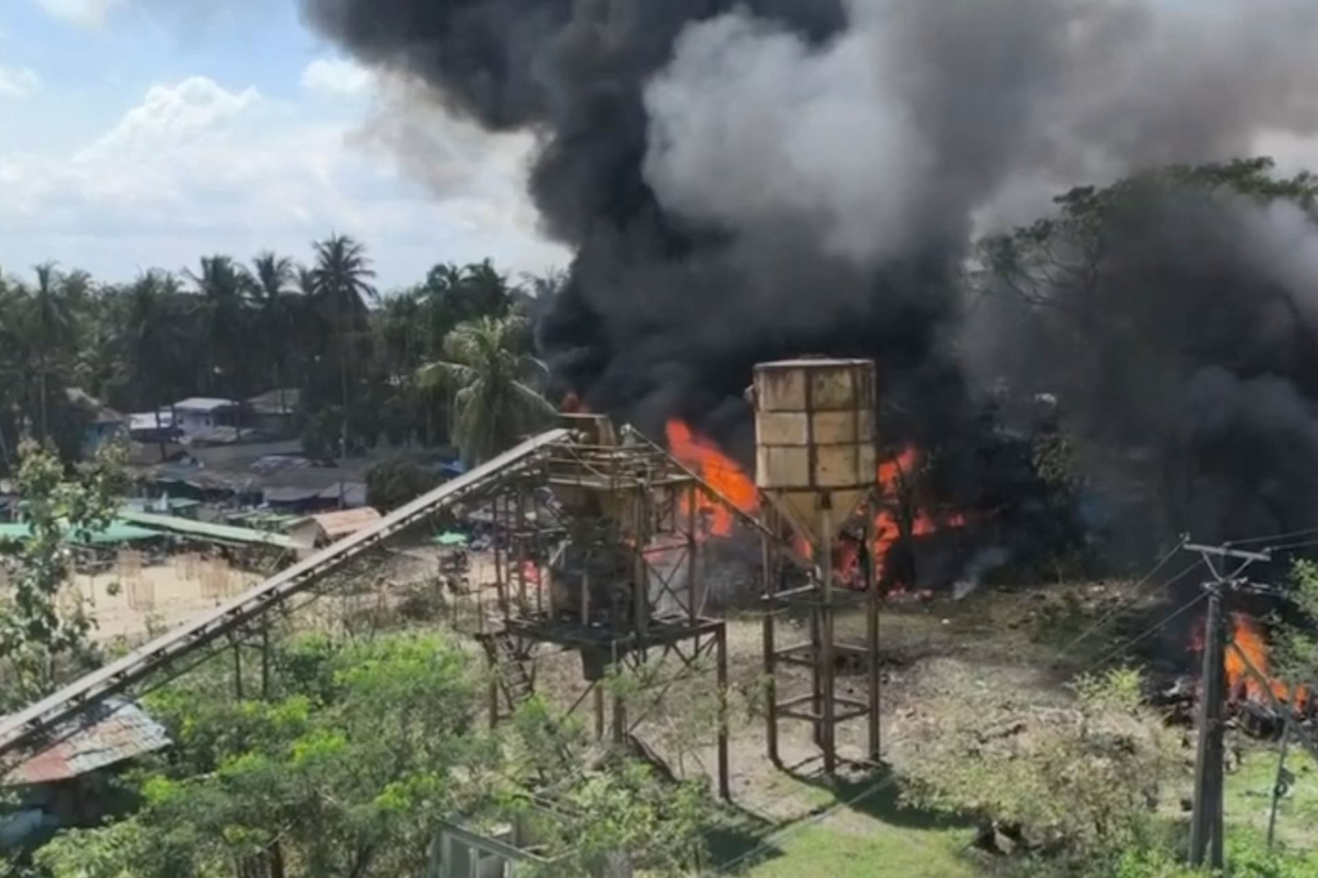 Smoke rises as fire burns following a Myanmar military airstrike, according to a rebel group that controls the area and a local aid worker, in Kyauktaw, Rakhine State, Myanmar, in this screen grab obtained from a social media video released September 28, 2026. Social Media/via REUTERS THIS IMAGE HAS BEEN SUPPLIED BY A THIRD PARTY. NO RESALES. NO ARCHIVES. NEWS USE ONLY. VERIFICATION: -Industrial infrastructure, bridge, trees, terrain, and utility tower matched archive and satellite imagery -Exact date could not be verified -Local media reported there was an airstrike in the area on September 28 -Rebel group Arakan Army said 33 people died in an airstrike in Kyauktaw on September 28 -A local aid worker also said the incident happened on September 28
