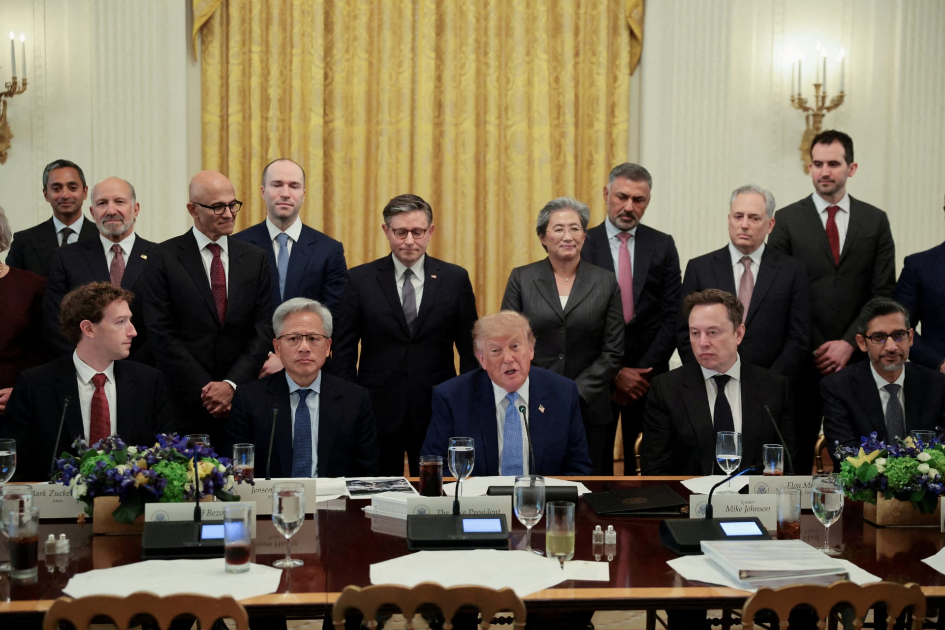 Technology executives and U.S. officials gather around a long table in the White House East Room.